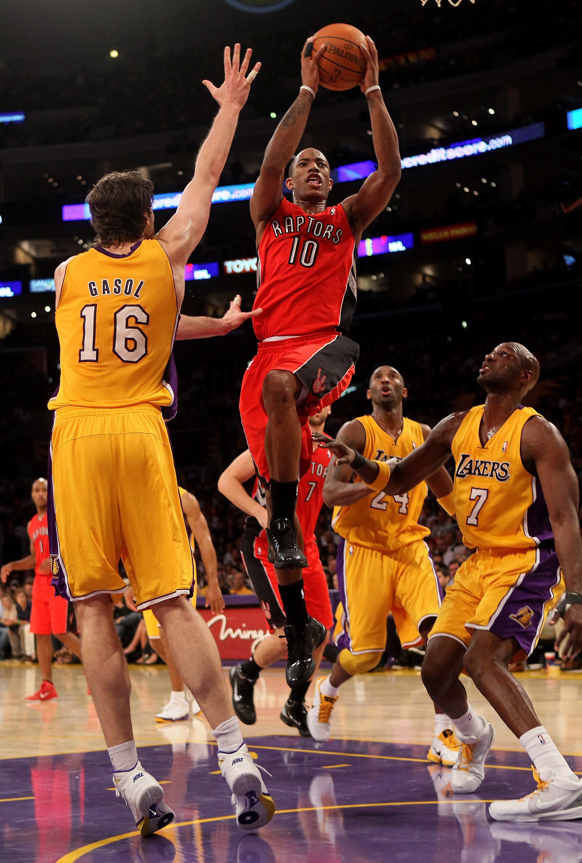LOS ANGELES - NOVEMBER 5: DeMar DeRozan #10 of the Toronto Raptors goes up for a shot between Pau Gasol #16 and Lamar Odom #7 of the Los Angeles Lakers at Staples Center on November 5, 2010 in Los Angeles, California.  The Lakers won 108-102.   NOTE TO US