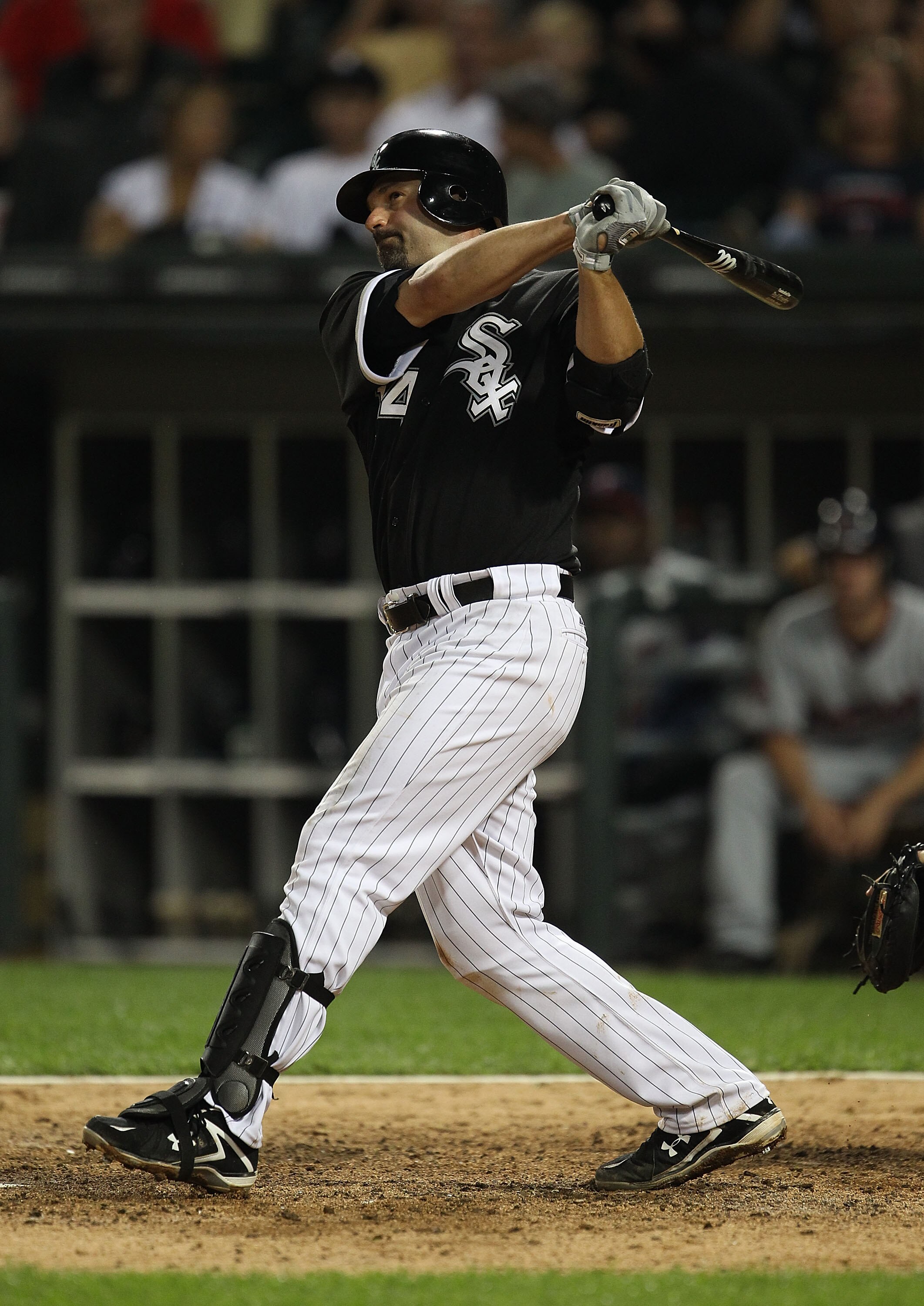 CHICAGO - AUGUST 10: Paul Konerko #14 of the Chicago White Sox hits a double against the Minnesota Twins at U.S. Cellular Field on August 10, 2010 in Chicago, Illinois. The Twins defeated the White Sox 12-6. (Photo by Jonathan Daniel/Getty Images)