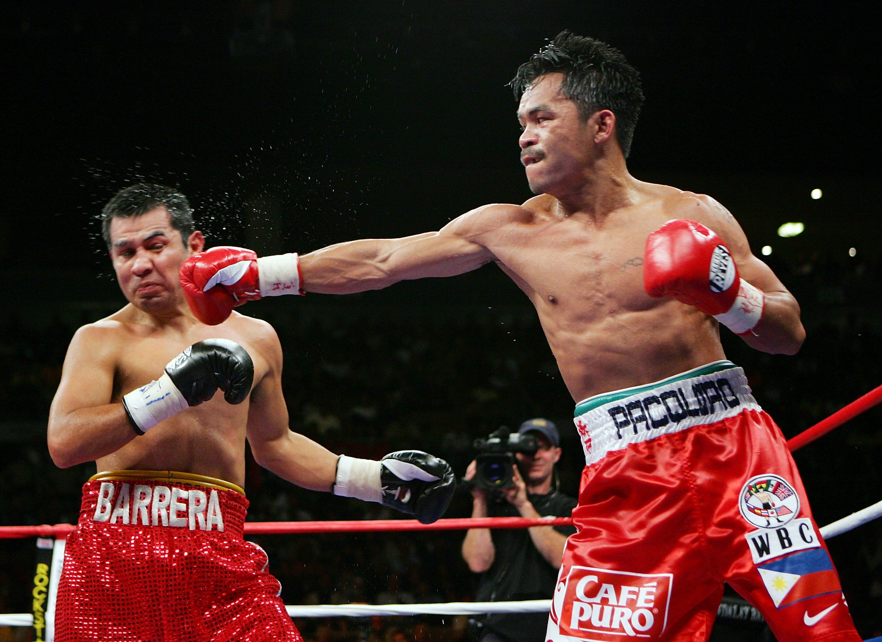 LAS VEGAS - OCTOBER 06:  Manny Pacquiao (R) hits Marco Antonio Barrera during the eighth round of their 12-round super featherweight bout at the Mandalay Bay Events Center October 6, 2007 in Las Vegas, Nevada. Pacquiao won by unanimous decision.  (Photo b