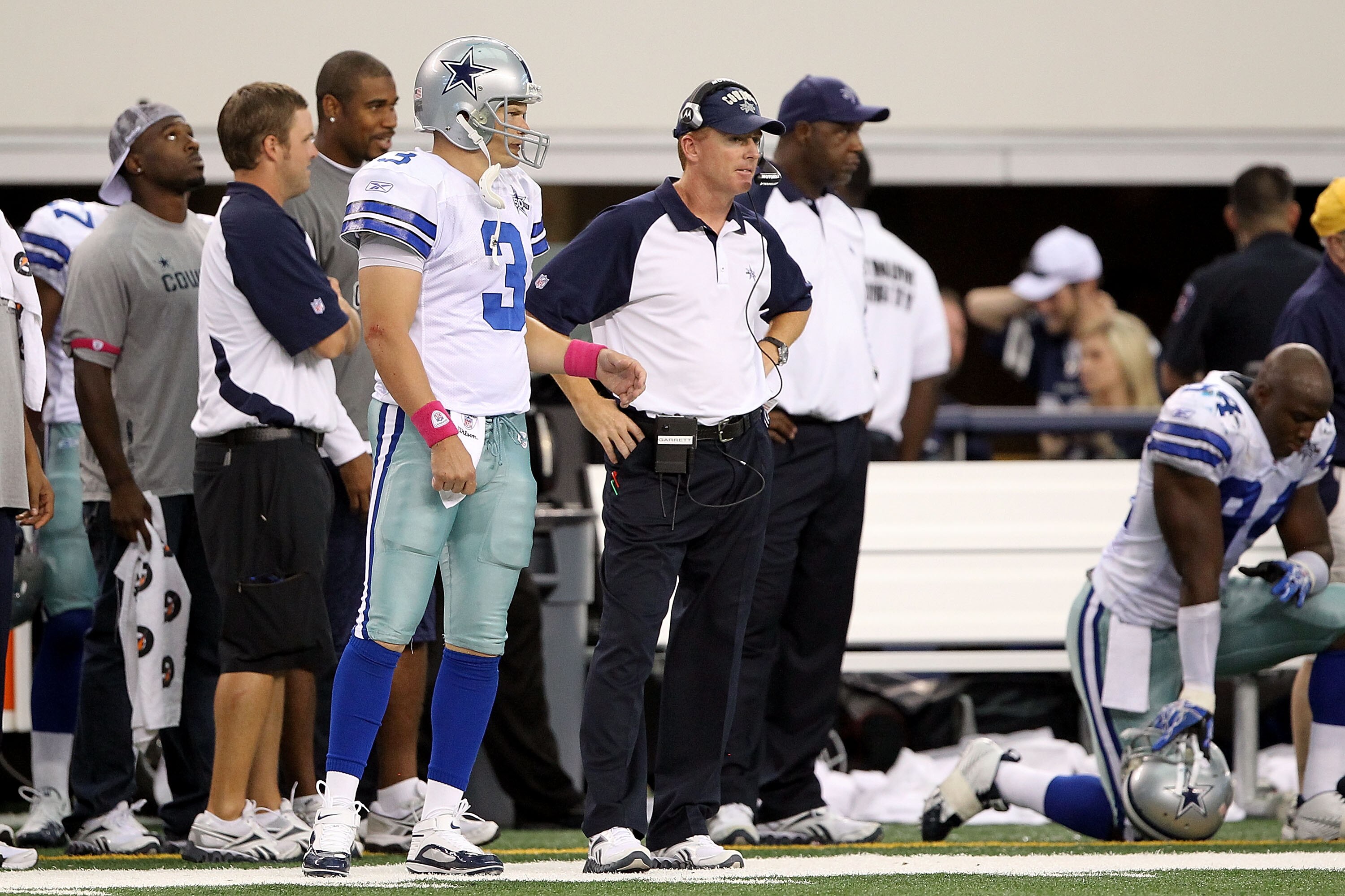 ARLINGTON, TX - OCTOBER 31:  (L-R) Quarterback Jon Kitna and assistant head coahc/offensive coordinator Jason Garrett of the Dallas Cowboys look on from the sideline against the Jacksonville Jaguars at Cowboys Stadium on October 31, 2010 in Arlington, Tex