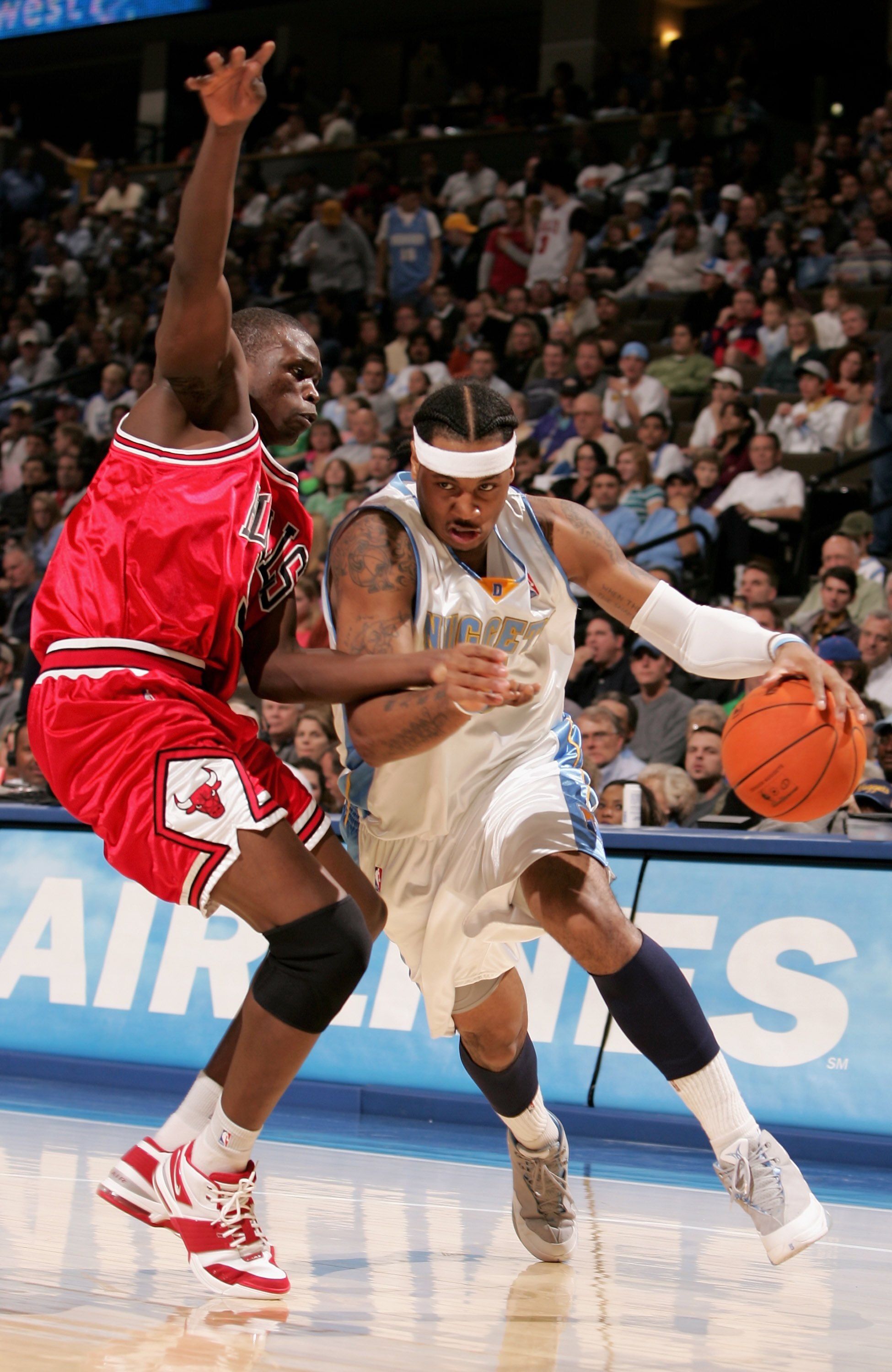 DENVER - NOVEMBER 21:  Carmelo Anthony #15 of the Denver Nuggets drives past Luol Deng #9 of the Chicago Bulls in NBA action on November 21, 2006 at the Pepsi Center in Denver, Colorado. The Nuggets defeated the Bulls 113-109.  NOTE TO USER: User expressl