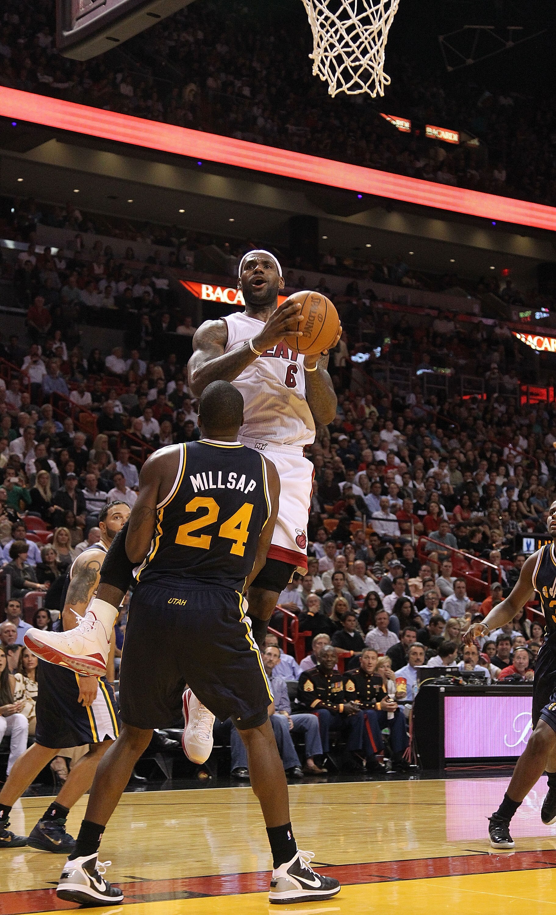 MIAMI - NOVEMBER 09:  Lebron James #6 of the Miami Heat drives to the hoop against Paul Millsap #24  during a game against the Utah Jazz at American Airlines Arena on November 9, 2010 in Miami, Florida. NOTE TO USER: User expressly acknowledges and agrees