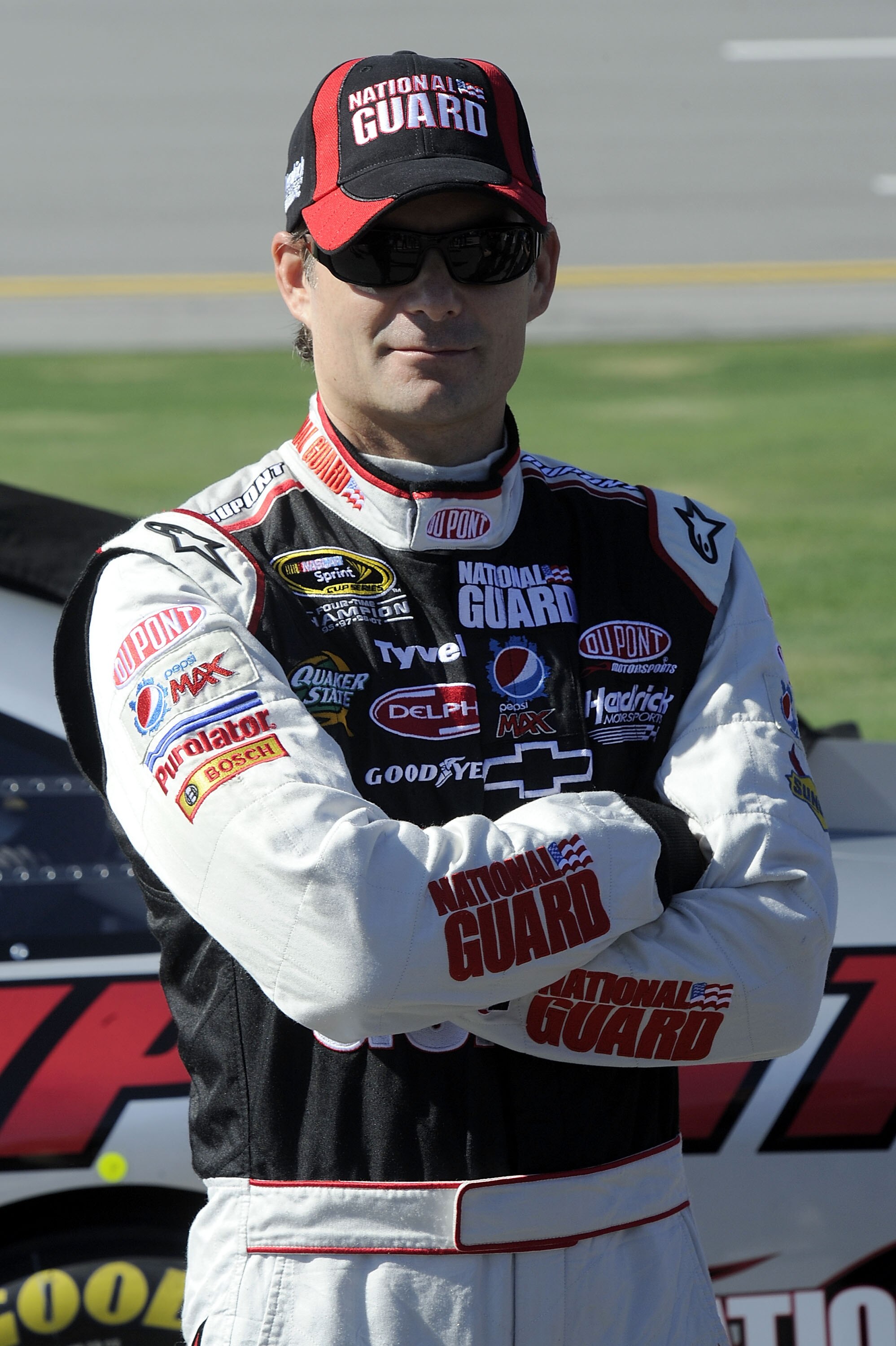TALLADEGA, AL - OCTOBER 30:  Jeff Gordon, driver of the #24 DuPont/National Guard Chevrolet, stands next to his car on pit road during qualifying for the NASCAR Sprint Cup Series AMP Energy Juice 500 at Talladega Superspeedway on October 30, 2010 in Talla