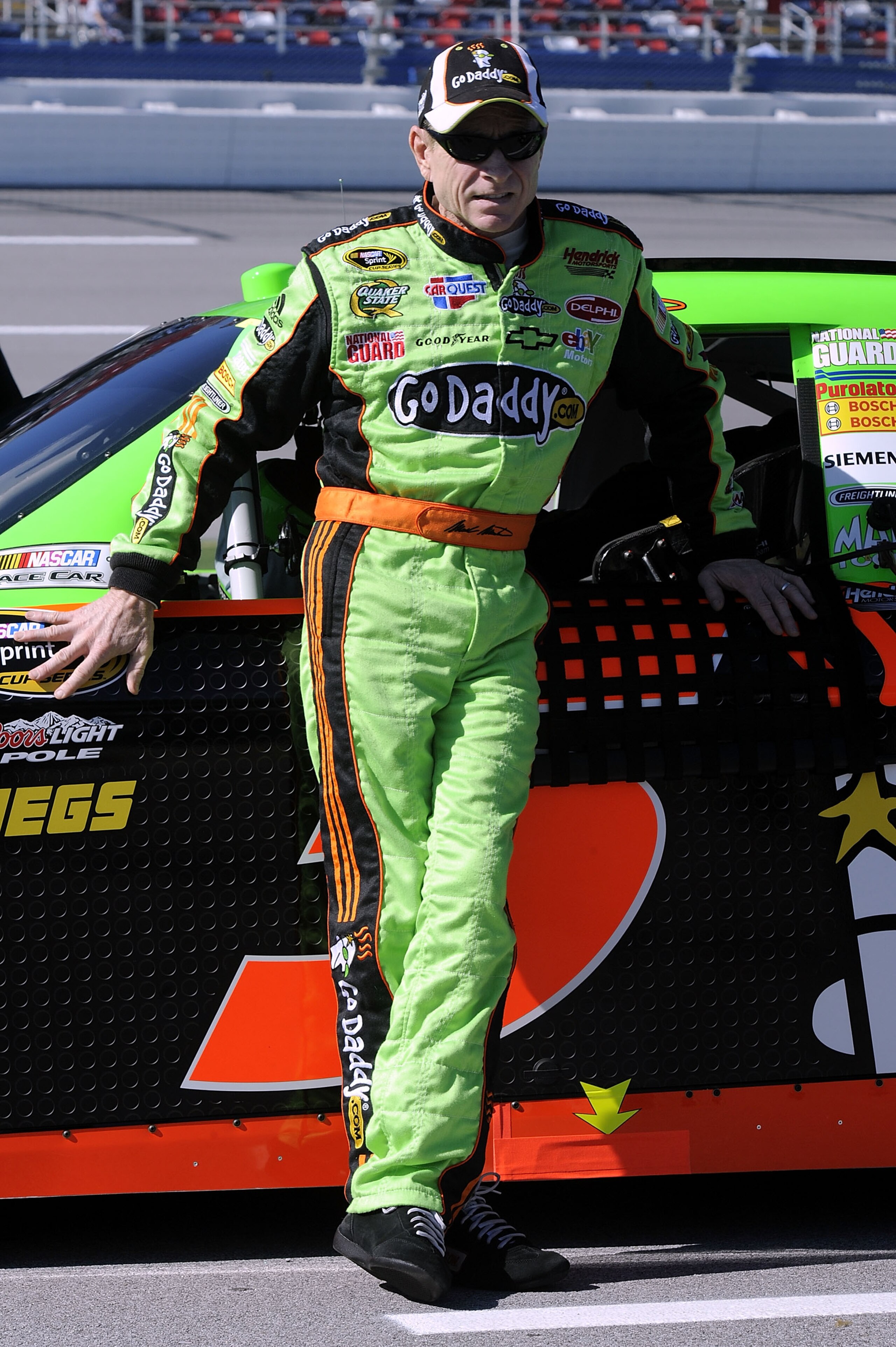 TALLADEGA, AL - OCTOBER 30:  Mark Martin, driver of the #5 GoDaddy.com Chevrolet, stands next to his car on pit road during qualifying for the NASCAR Sprint Cup Series AMP Energy Juice 500 at Talladega Superspeedway on October 30, 2010 in Talladega, Alaba