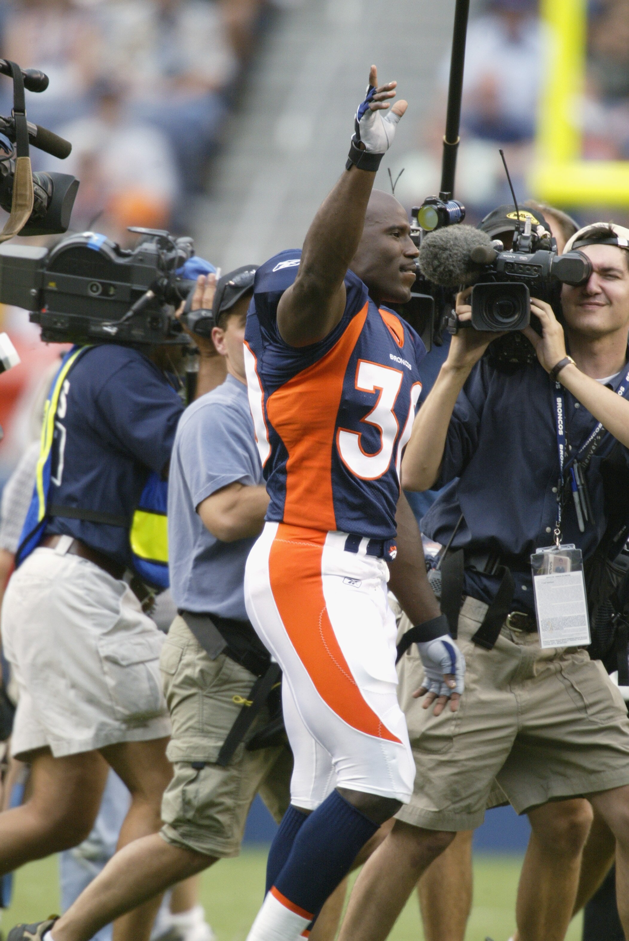 DENVER - AUGUST 19:  Running back Terrell Davis #30 of the Denver Broncos waves and salutes to the crowd before a preseason game against the San Francisco 49ers August 19, 2002, at Mile High Stadium in Denver, Colorado.   Davis did not play and is expecte