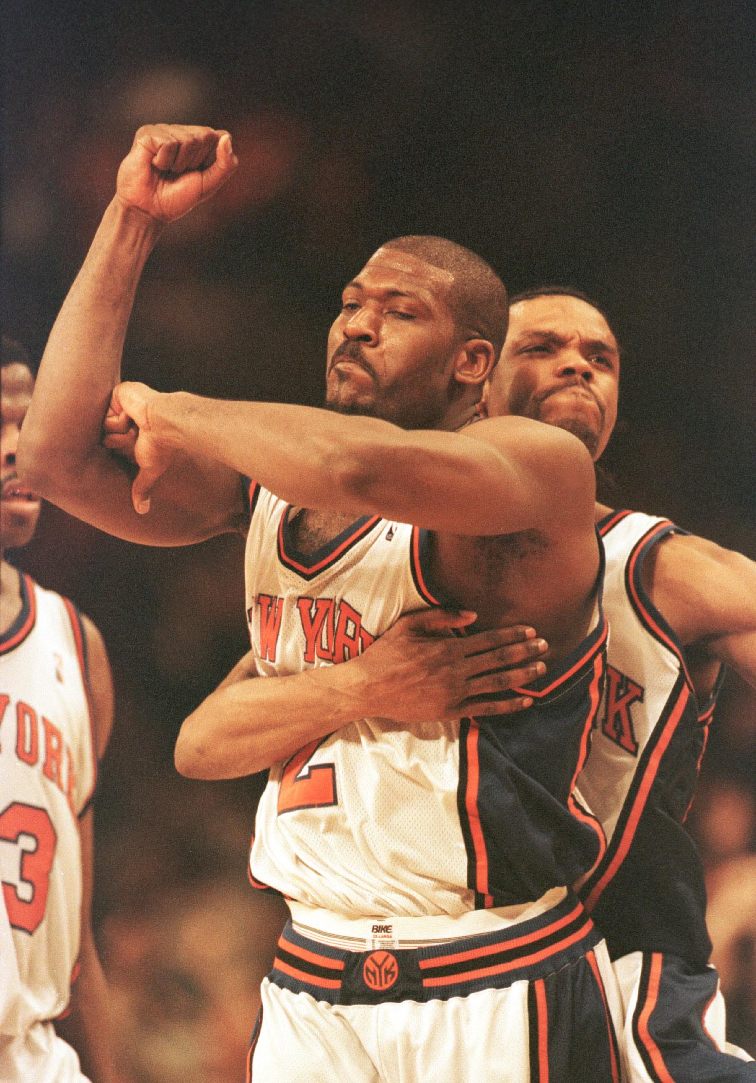 23 Apr 2000: Larry Johnson #2 of the New York Knicks is hugged from behind by teammate Latrell Sprewell after Johnson hit a three-point basket to give the Knicks a 88-85 win over the Toronto Raptors at Madison Square Garden in New York City. The Knicks le