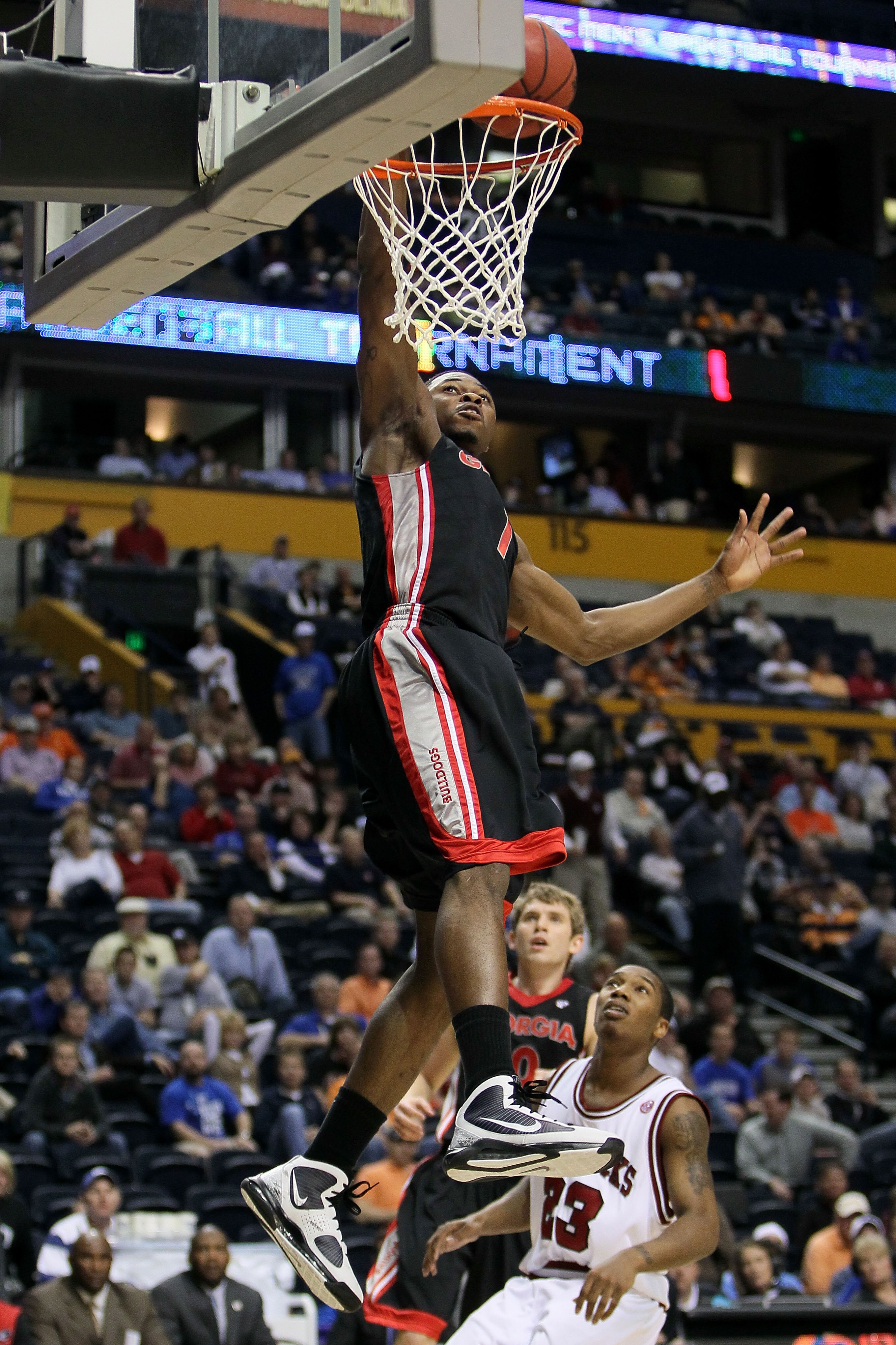 NASHVILLE, TN - MARCH 11:  Travis Leslie #1 of the Georgia Bulldogs goes up for a dunk attempt against Julysses Nobles #23 of the Arkanasas Razorbacks during the first round of the SEC Men's Basketball Tournament at the Bridgestone Arena on March 11, 2010