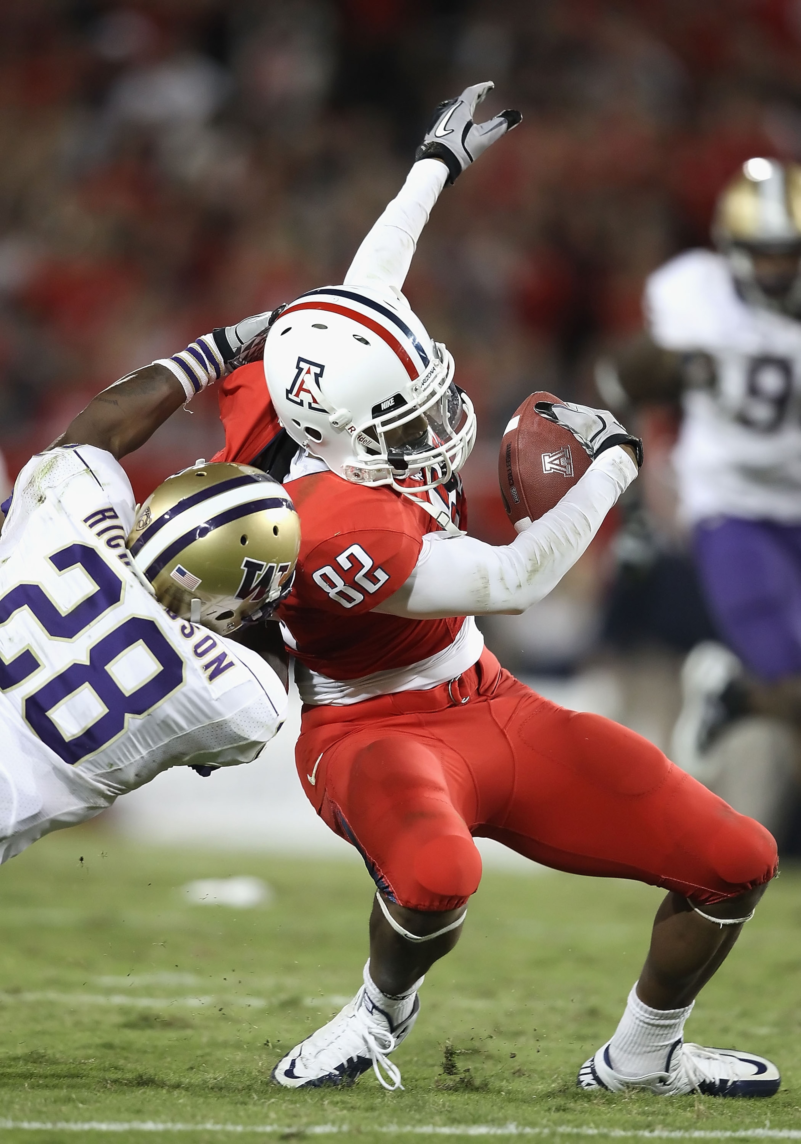 TUCSON, AZ - OCTOBER 23:  Wide receiver Juron Criner #82 of the Arizona Wildcats runs with the ball during the college football game against the Washington Huskies at Arizona Stadium on October 23, 2010 in Tucson, Arizona.   The Wildcats defeated the Husk