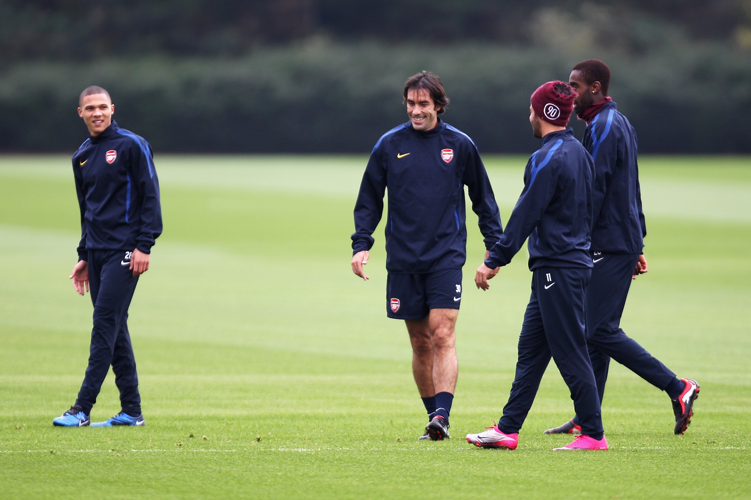 ST ALBANS, ENGLAND - OCTOBER 18: Former Arsenal player Robert Pires (C) shares a joke with players during a training session ahead of the UEFA Champions League game against Shakhtar Donetsk at the club's complex at London Colney on October 18, 2010 in St ST ALBANS, ENGLAND - OCTOBER 18: Former Arsenal player Robert Pires (C) shares a joke with players during a training session ahead of the UEFA Champions League game against Shakhtar Donetsk at the club's complex at London Colney on October 18, 2010 in St