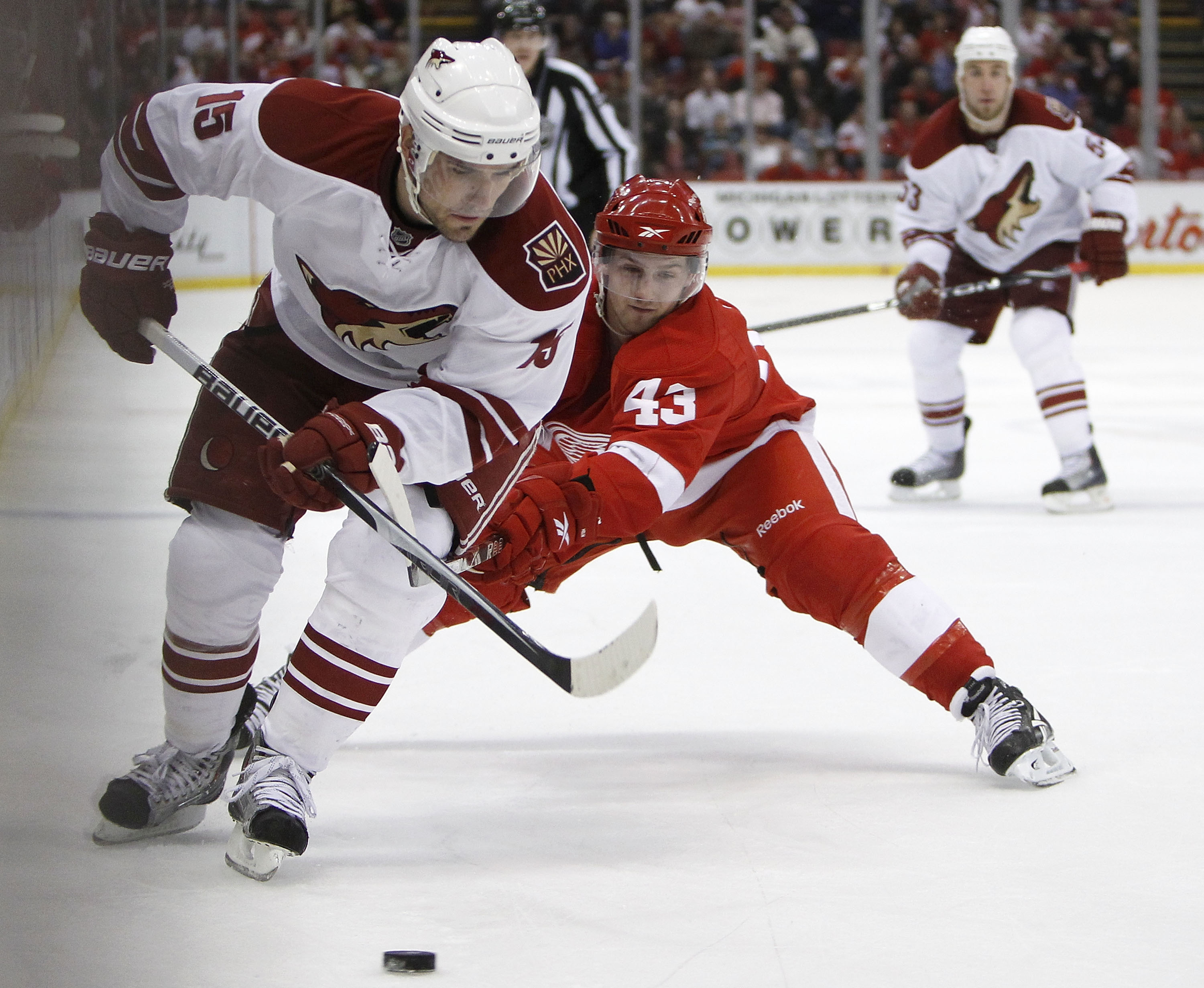 DETROIT - APRIL 20: Matthew Lombardi #15 of the Phoenix Coyotes tries to control the puck in front of Darren Helm #43 of the Detroit Red Wings during Game Four of the Western Conference Quarterfinals of the 2010 NHL Stanley Cup Playoffs on April 20, 2010