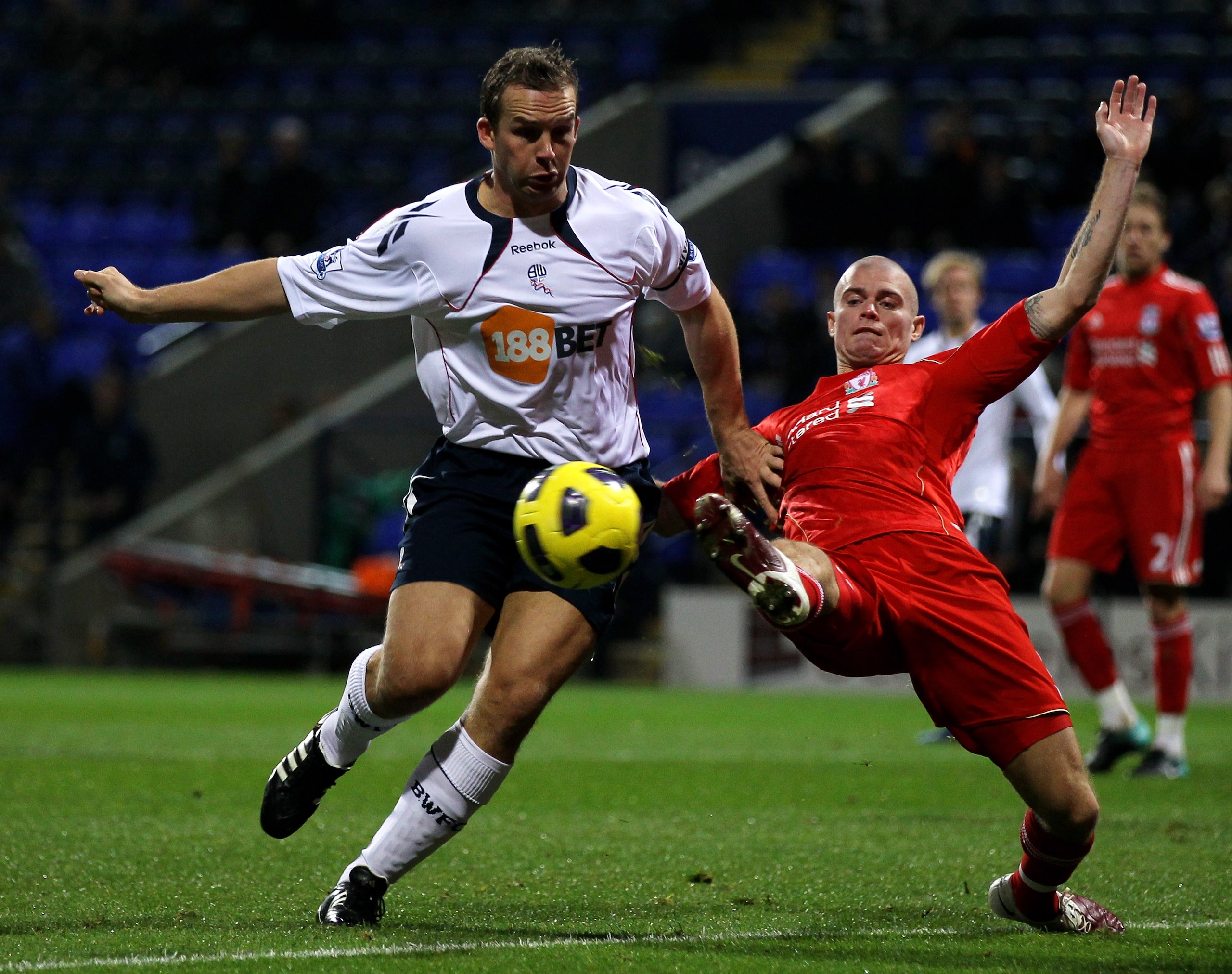 BOLTON, ENGLAND - OCTOBER 31:  Paul Konchesky of Liverpool challenges Kevin Davies of Bolton Wanderers during the Barclays Premier League match between Bolton Wanderers and Liverpool at the Reebok Stadium on October 31, 2010 in Bolton, England. (Photo by