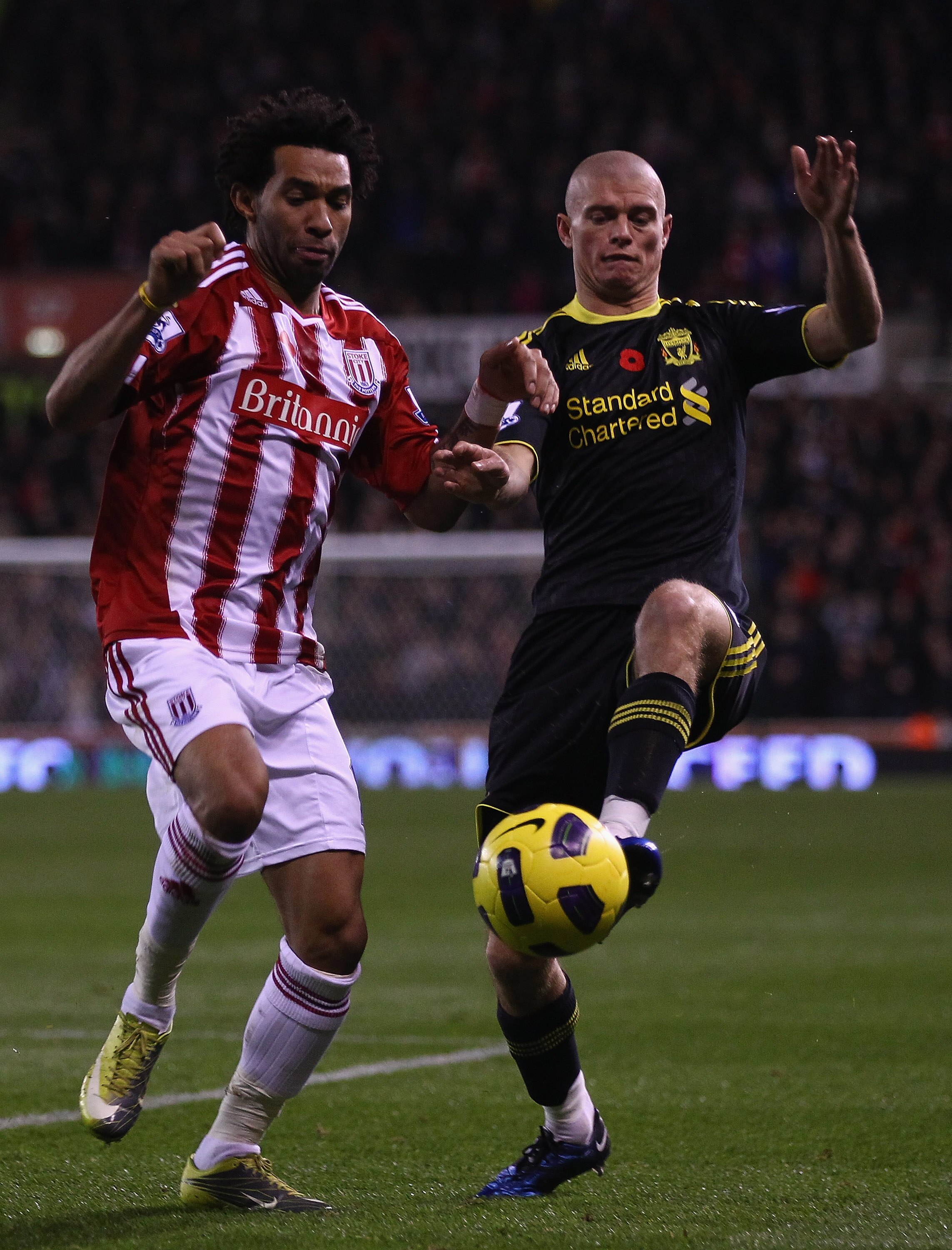 STOKE ON TRENT, ENGLAND - NOVEMBER 13: Paul Konchesky of Liverpool in action with Jermaine Pennant of Stoke City during the Barclays Premier League match between Stoke City and Liverpool at Britannia Stadium on November 13, 2010 in Stoke on Trent, England