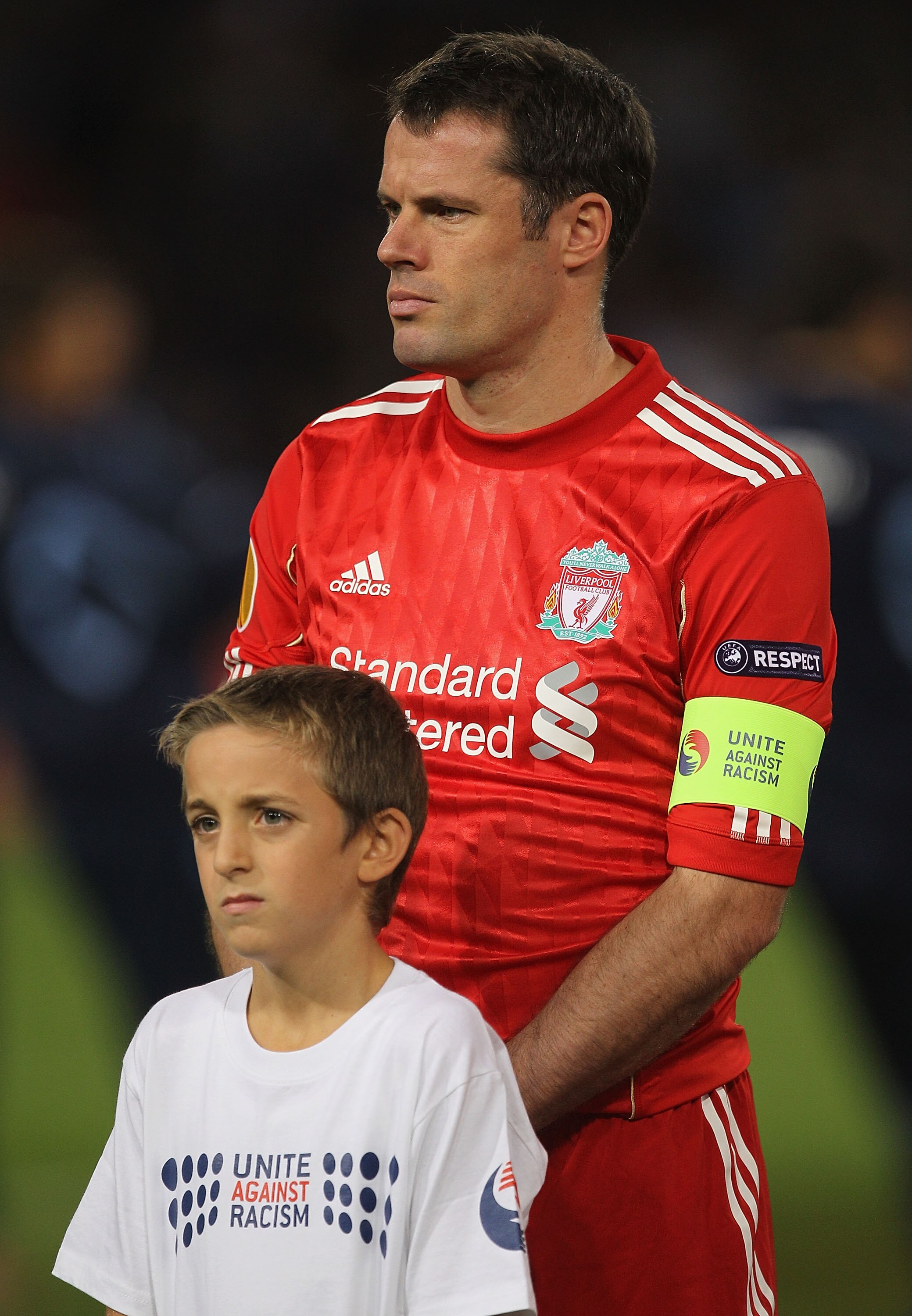 NAPLES, ITALY - OCTOBER 21:  Jamie Carragher of Liverpool and his mascot show their support for the Unite Against Racism campaign ahead of the UEFA Europa League match between SSC Napoli and Liverpool played at Stadio San Paolo on October 21, 2010 in Napl