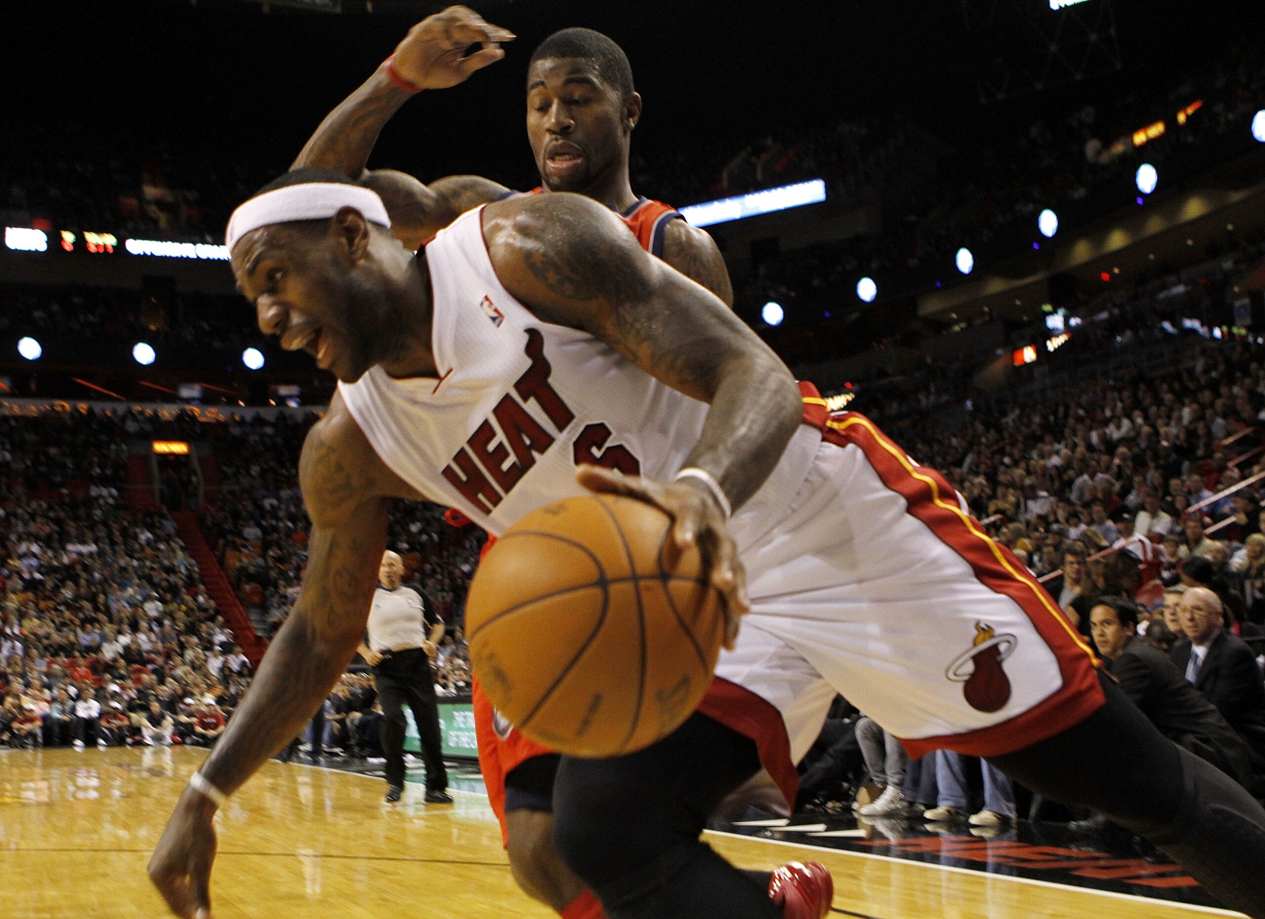 MIAMI - NOVEMBER 06:  Forward LeBron James #6 of the Miami Heat drives against guard Terrence Williams #1 of the New Jersey Nets  at American Airlines Arena on November 6, 2010 in Miami, Florida. NOTE TO USER: User expressly acknowledges and agrees that,