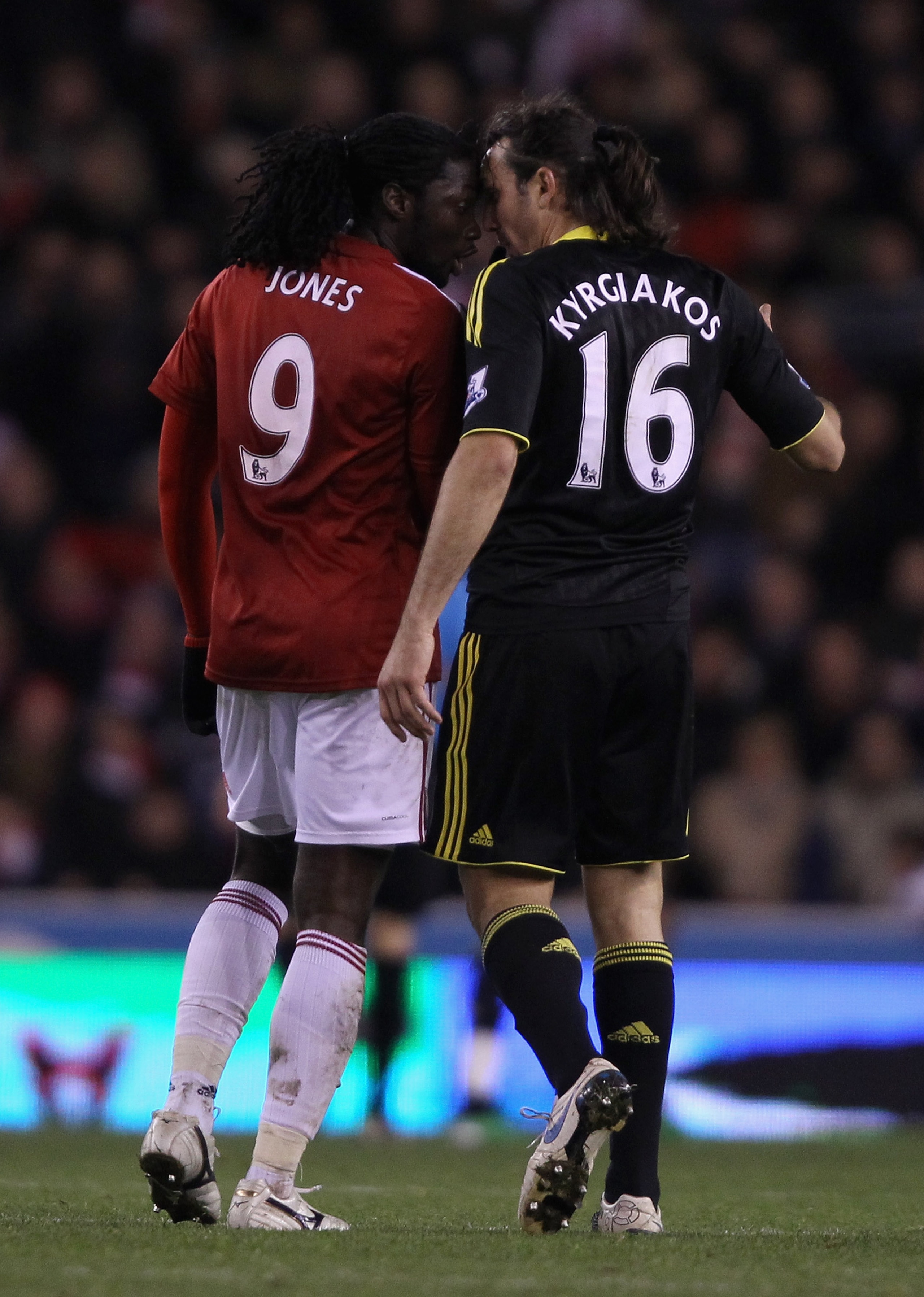 STOKE ON TRENT, ENGLAND - NOVEMBER 13: Sotirios Kyrgiakos of Liverpool goes head to head with Kenwyne Jones of Stoke City after a bad tackle during the Barclays Premier League match between Stoke City and Liverpool at Britannia Stadium on November 13, 201