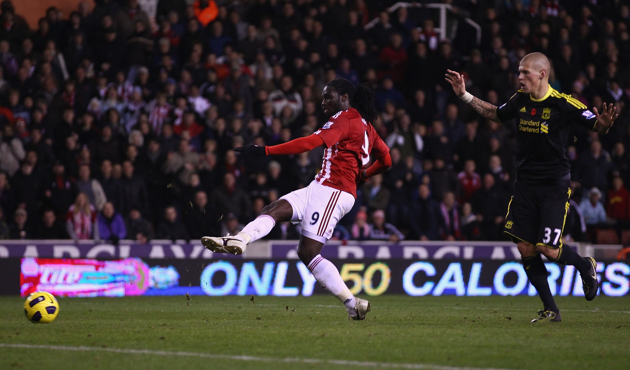 STOKE ON TRENT, ENGLAND - NOVEMBER 13:  Kenwyne Jones of Stoke City scores the second goal as Martin Skrtel of Liverpool looks on during the Barclays Premier League match between Stoke City and Liverpool at Britannia Stadium on November 13, 2010 in Stoke