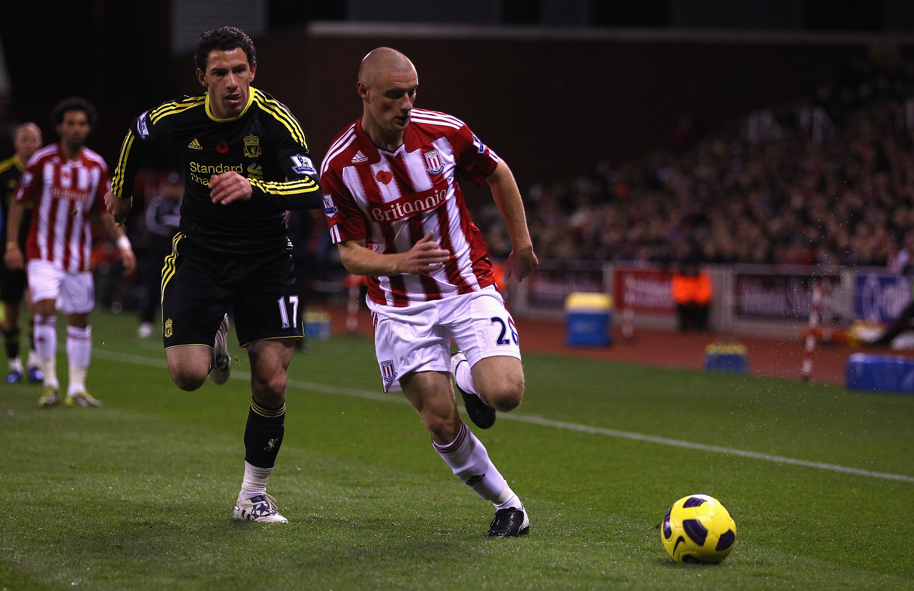 STOKE ON TRENT, ENGLAND - NOVEMBER 13: Andy Wilkinson of Stoke City attempts to move away from Maxi Rodriguez of Liverpool during the Barclays Premier League match between Stoke City and Liverpool at Britannia Stadium on November 13, 2010 in Stoke on Tren