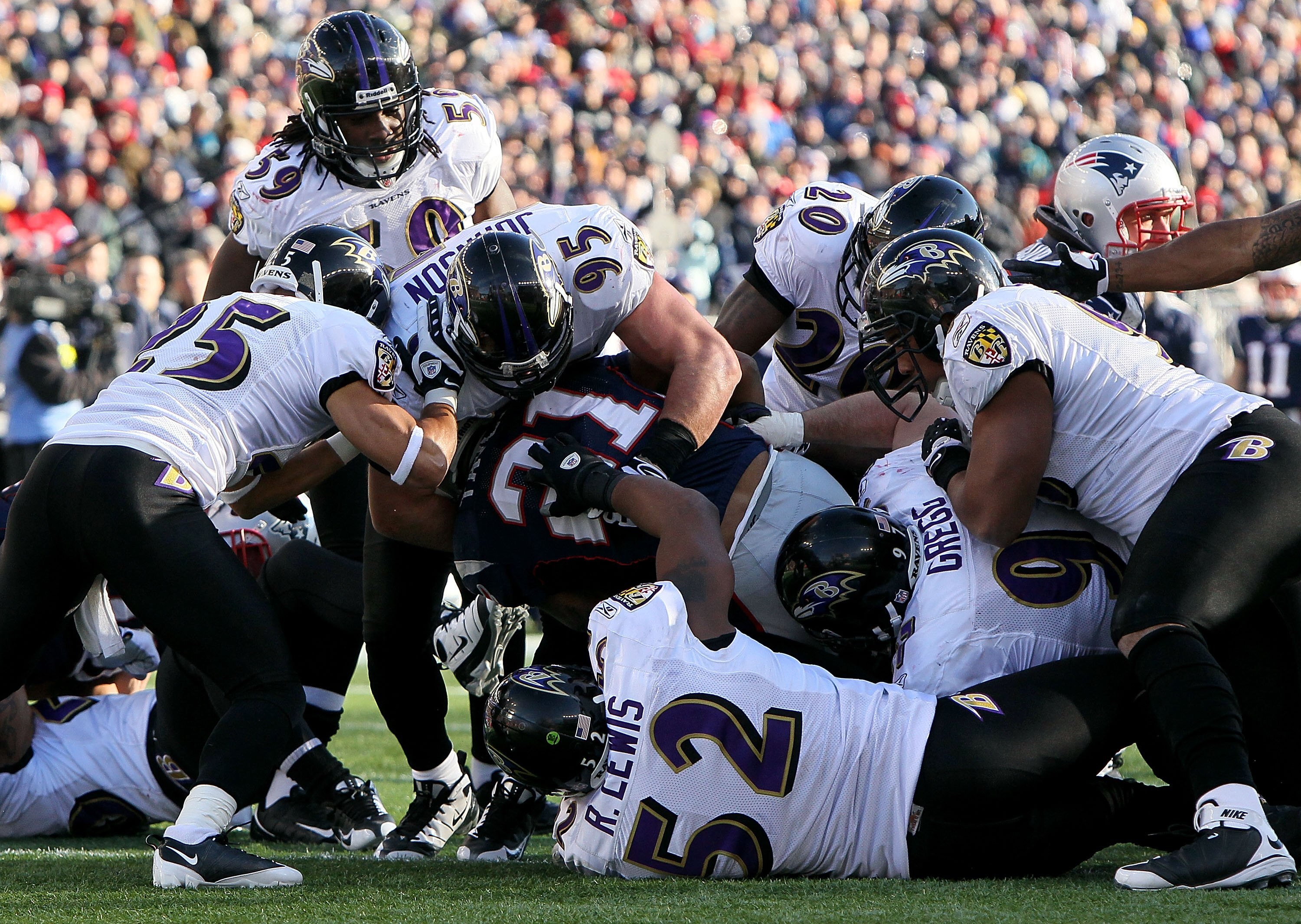 FOXBORO, MA - JANUARY 10:  The Baltimore Ravens defense stops Fred Taylor #21 of the New England Patriots during the 2010 AFC wild-card playoff game at Gillette Stadium on January 10, 2010 in Foxboro, Massachusetts.  (Photo by Al Bello/Getty Images)