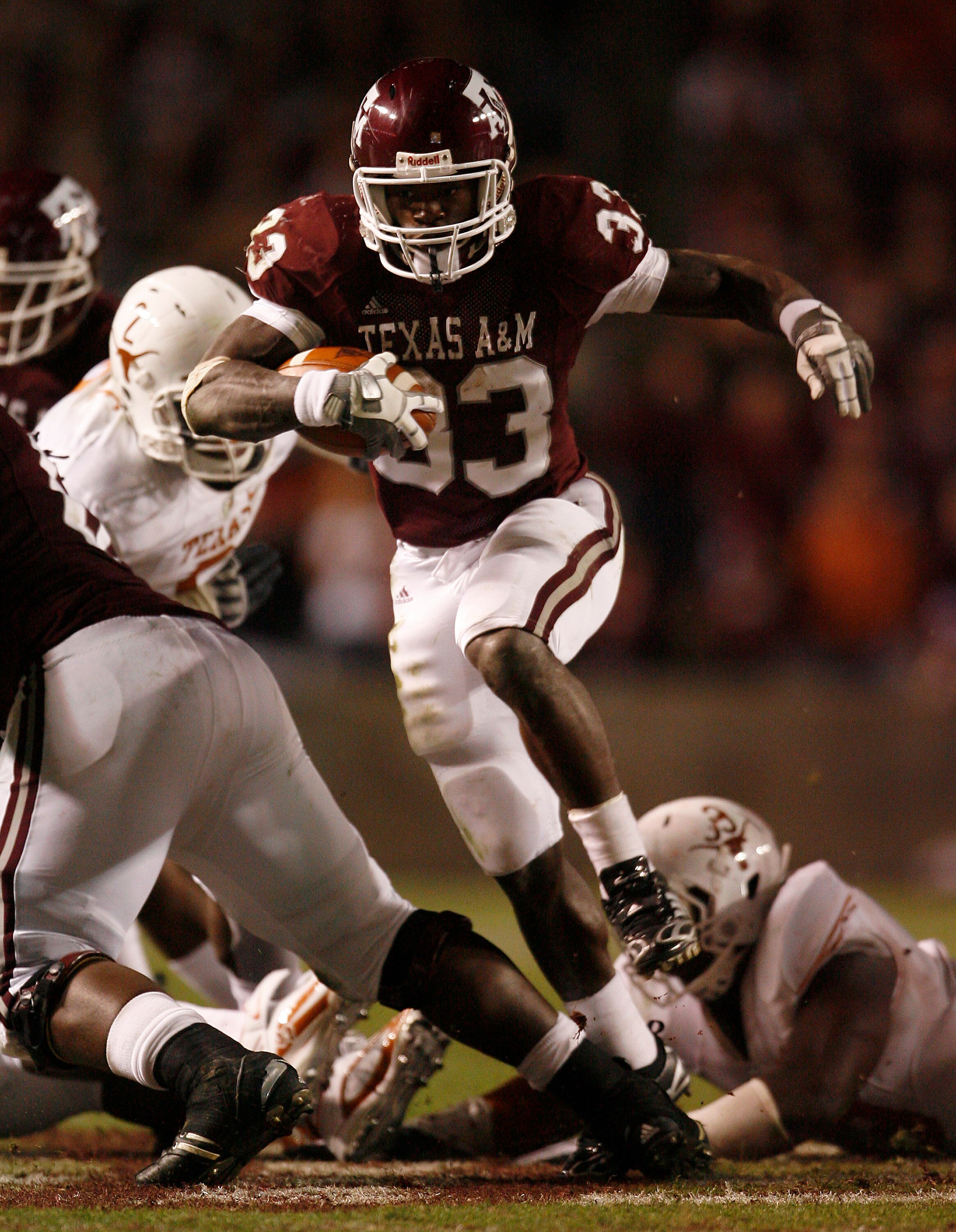 COLLEGE STATION, TX - NOVEMBER 26: Tailback Christine Michael #33 of the Texas A&M Aggies rushes for a gain against the Texas Longhorns defense in the second half at Kyle Field on November 26, 2009 in College Station, Texas. The Longhorns defeated the Agg