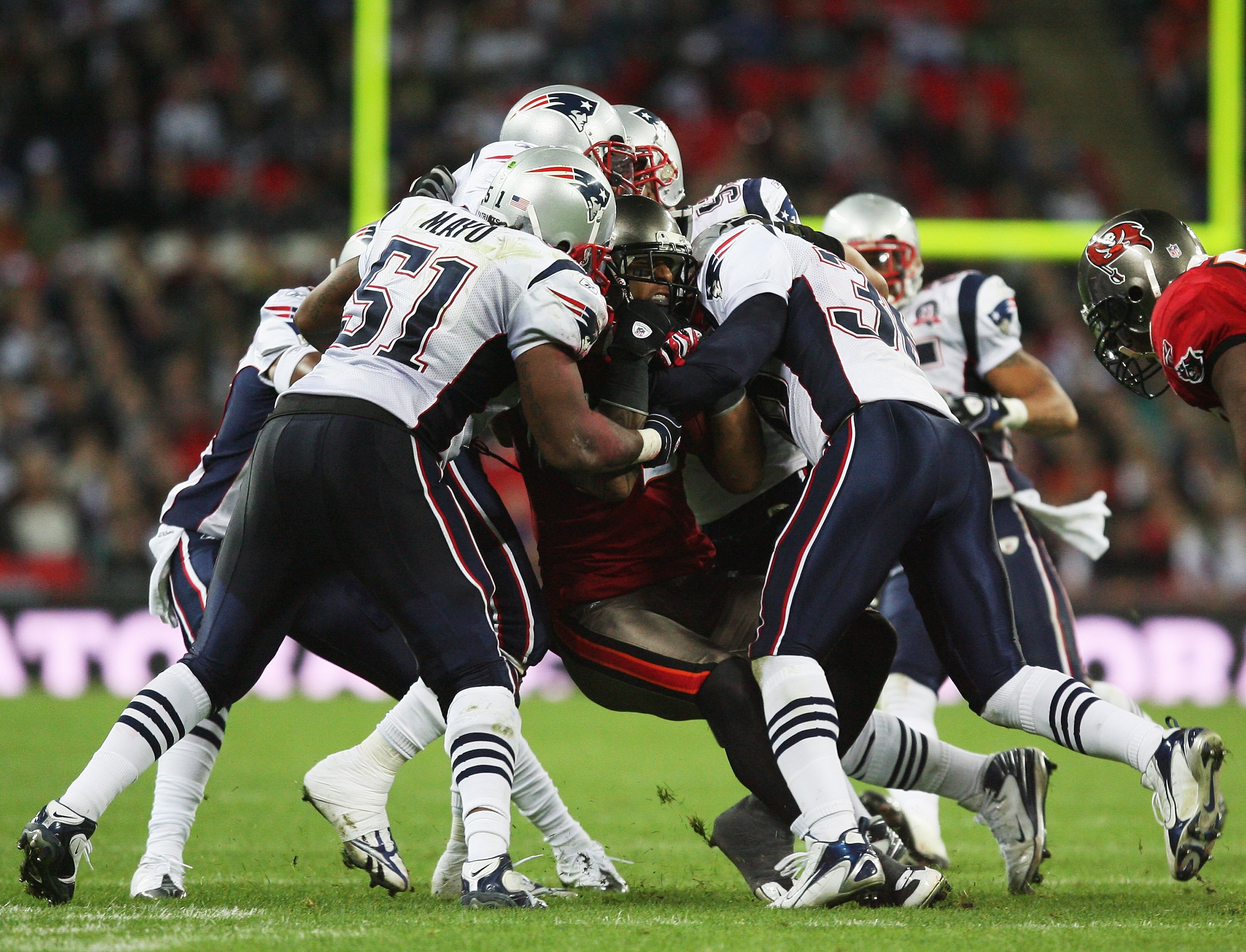 LONDON, ENGLAND - OCTOBER 25:  Kellen Winslow (#82)of Tampa Bay Buccaneers is tackled by the New England Patriots defence during the NFL International Series match between New England Patriots and Tampa Bay Buccaneers at Wembley Stadium on October 25, 200