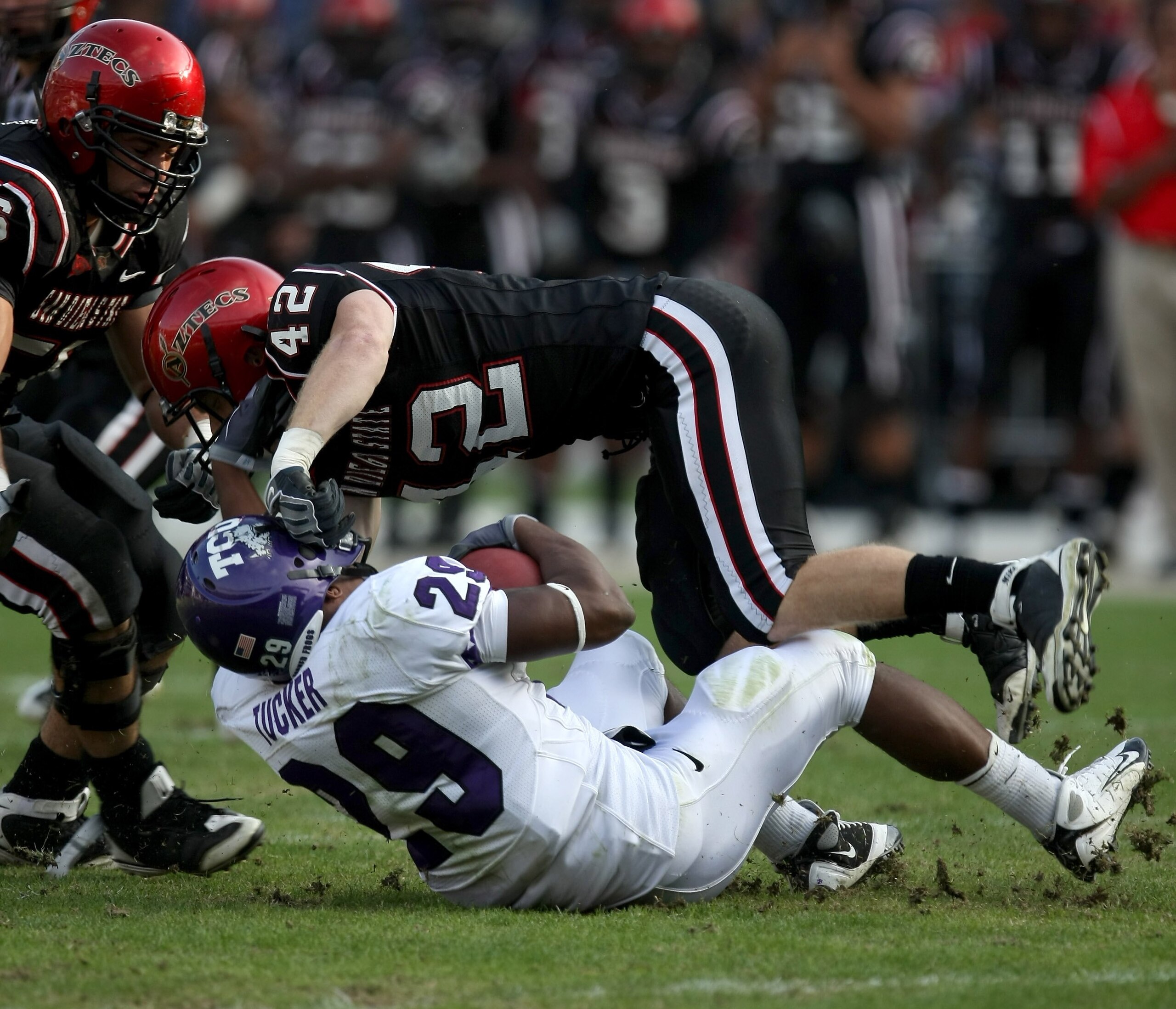 SAN DIEGO - NOVEMBER 07:  Running back Matthew Tucker #29 of the Texas Christian University Horned Frogs is tackled by defensive back Nick Sandford #42 of the San Diego State Aztecs on November 7, 2009 at Qualcomm Stadium in San Diego, California.   TCU w