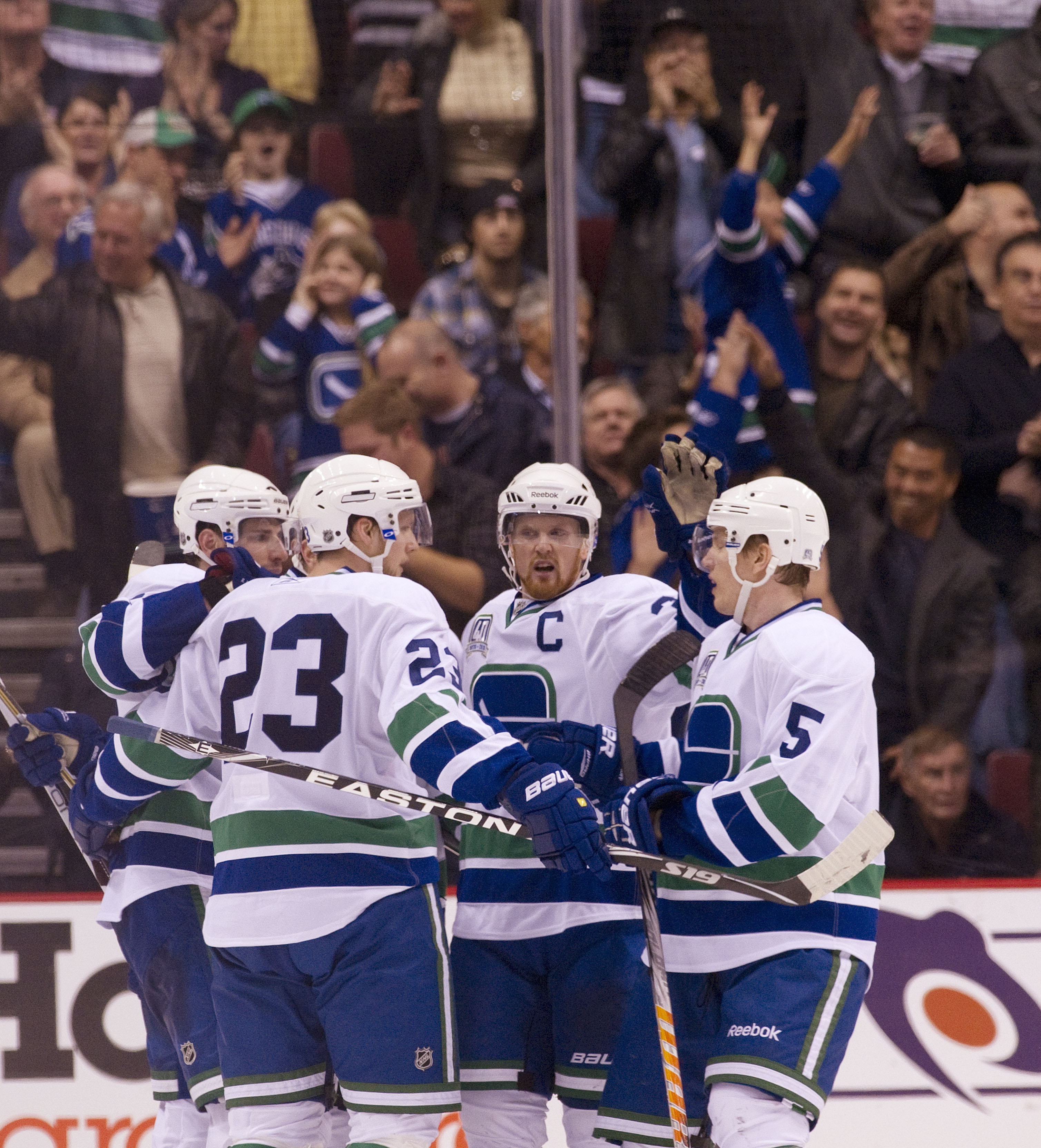 VANCOUVER, CANADA - NOVEMBER 6: Alexander Edler #23 of the Vancouver Canucks celebrates with Ryan Kesler #17, Henrik Sedin #33 and Christian Ehrhoff #5 after scoring what proved to be the game winning goal against the Detroit Red Wings during the third pe