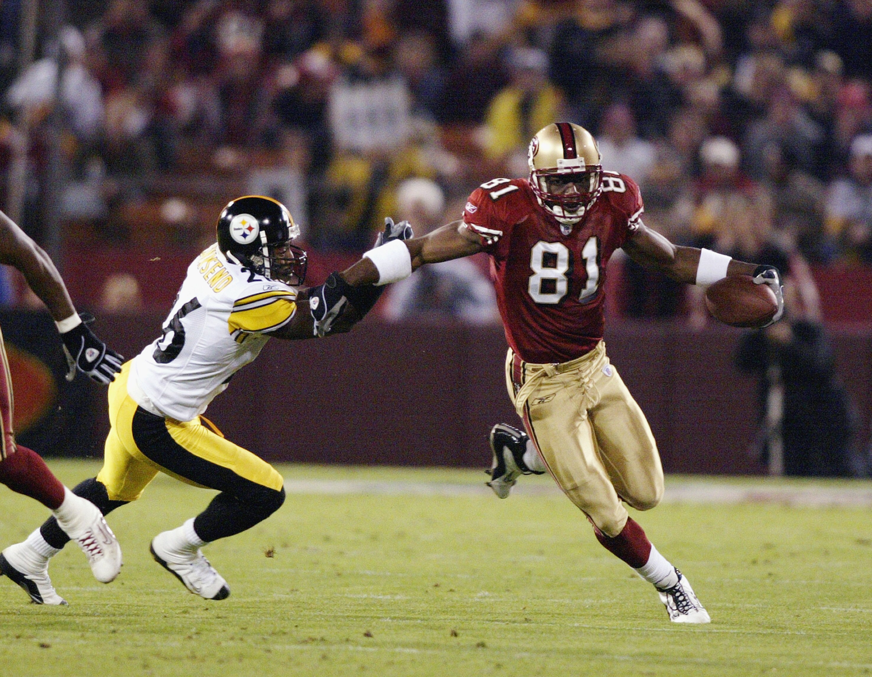 SAN FRANCISCO - NOVEMBER 17:  Wide receiver Terrell Owens #81 of the San Francisco 49ers avoids Deshea Townsend #26 of the Pittsburgh Steelers during the game at 3Com Park on November 17, 2003 in San Francisco, California. The 49ers defeated the Steelers