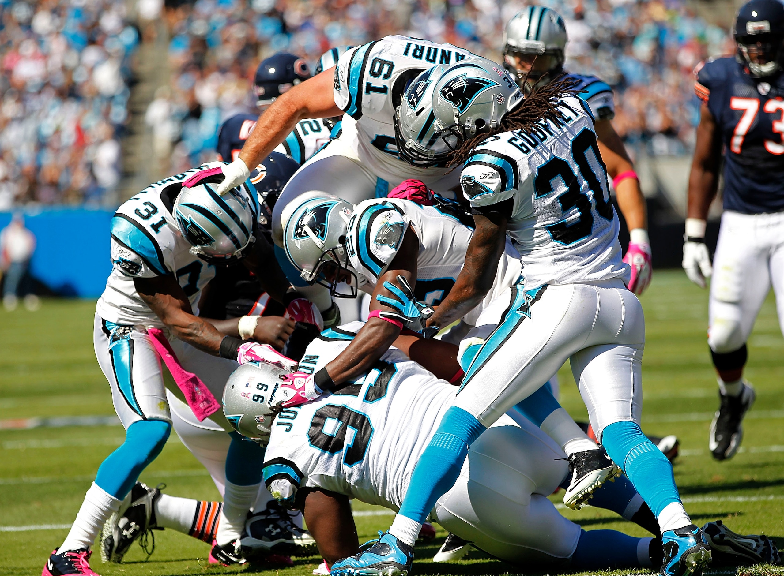 CHARLOTTE, NC - OCTOBER 10: Defensive tackle Ed Johnson #99 of the Carolina Panthers is mobbed by teammates after an interception against the Chicago Bears at Bank of America Stadium on October 10, 2010 in Charlotte, North Carolina. (Photo by Geoff Burke/