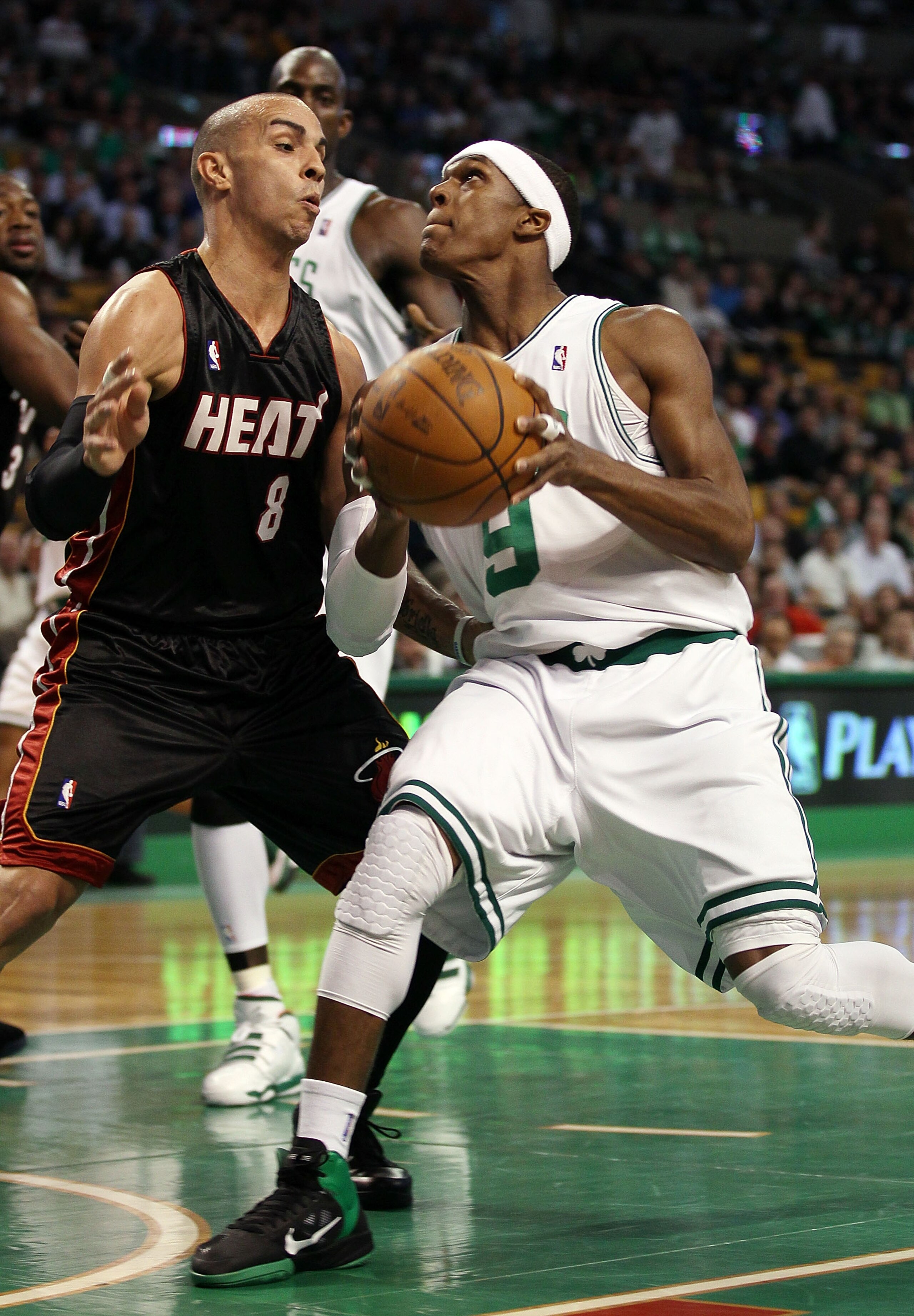 BOSTON - APRIL 27:  Rajon Rondo #9 of the Boston Celtics heads for the net as Carlos Arroyo #8 of the Miami Heat defends during Game Five of the Eastern Conference Quarterfinals of the 2010 NBA playoffs at the TD Garden on April 27, 2010 in Boston, Massac