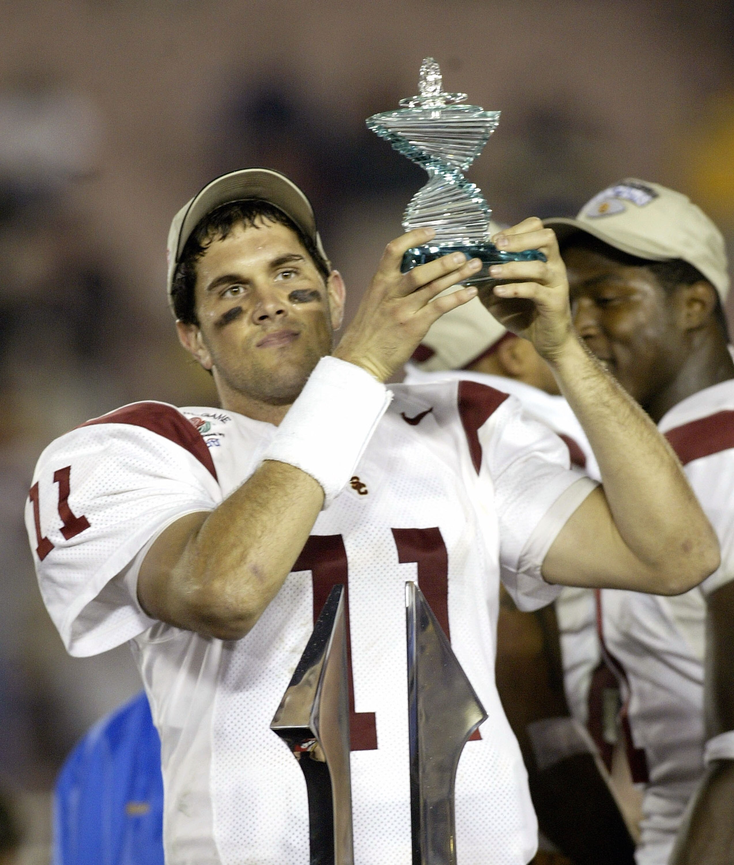 PASADENA, CA - JANUARY 1:  Quarterback Matt Leinart #11 of the USC Trojans holds up the trophy for Most Valuable Player of the 2004 Rose Bowl against the the Univerity of Michigan Wolverines on January 1, 2004 at the Rose Bowl in Pasadena, California. USC