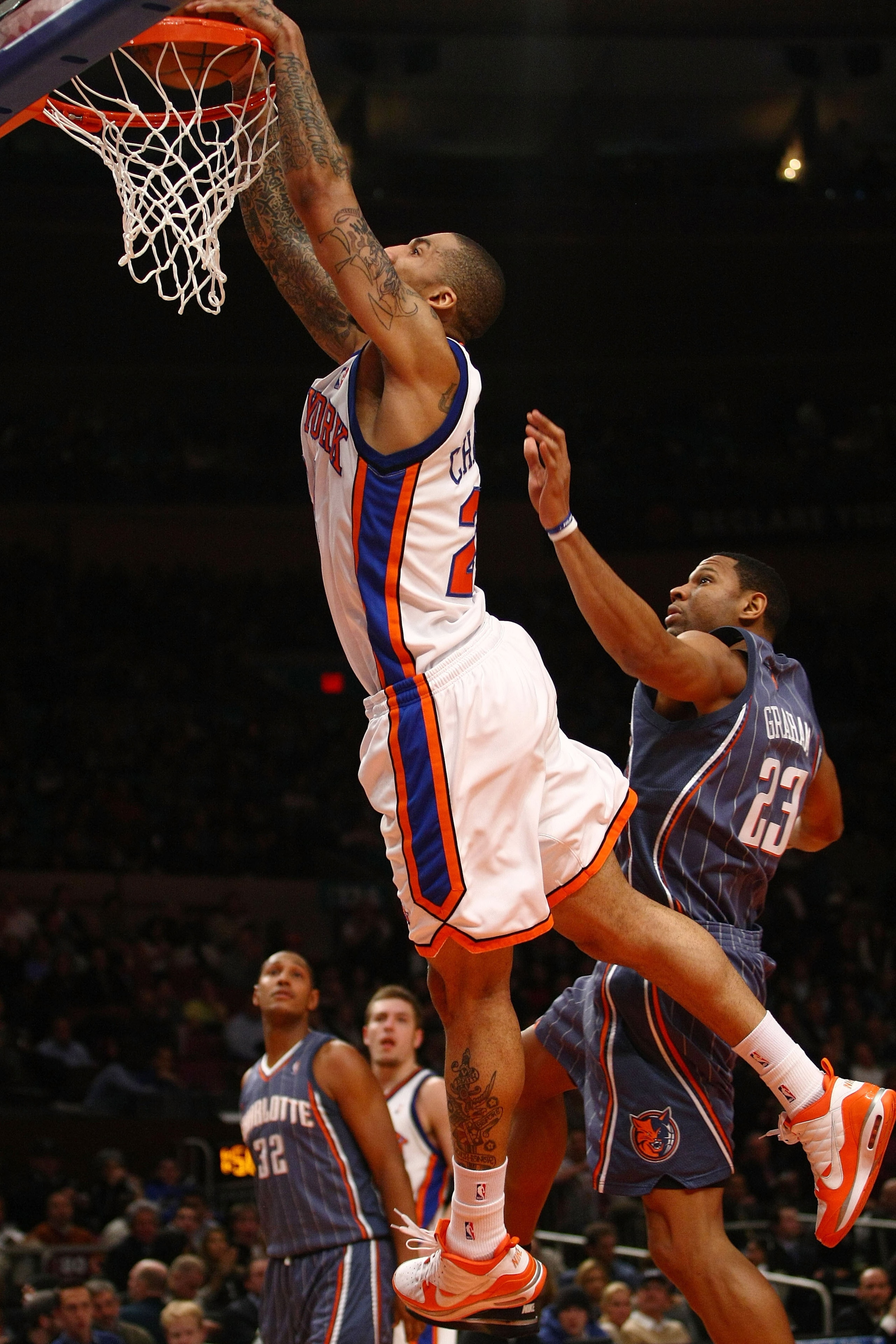 NEW YORK - JANUARY 07:  Wilson Chandler #21 of the New York Knicks dunks over Stephen Graham #23  of the Charlotte Bobcats at Madison Square Garden January 7, 2010 in New York City. NOTE TO USER: User expressly acknowledges and agrees that, by downloading