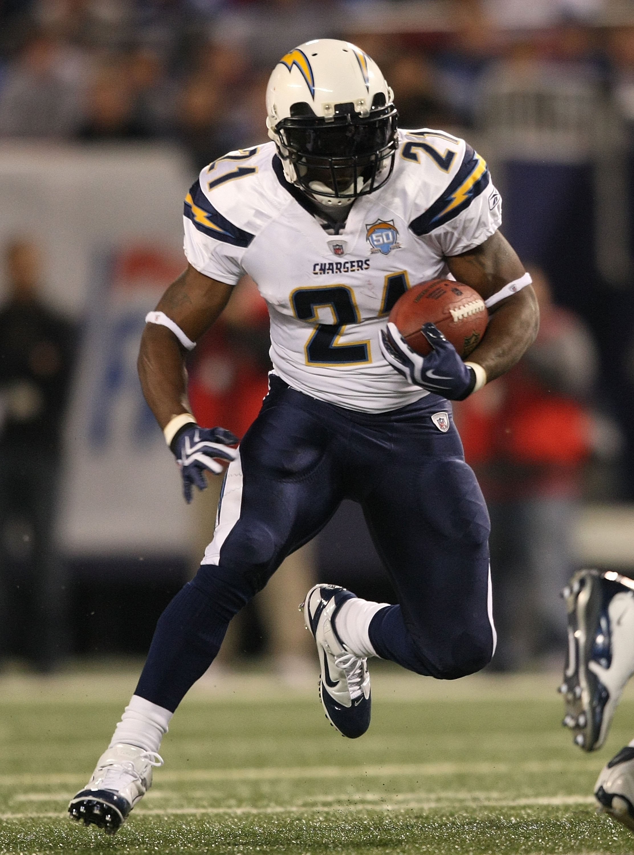 EAST RUTHERFORD, NJ - NOVEMBER 8:  LaDainian Tomlinson #21 of the San Diego Chargers rushes against the New York Giants at Giants Stadium on November 8, 2009 in East Rutherford, New Jersey. The Chargers defeated the Giants 21-20.  (Photo by Nick Laham/Get