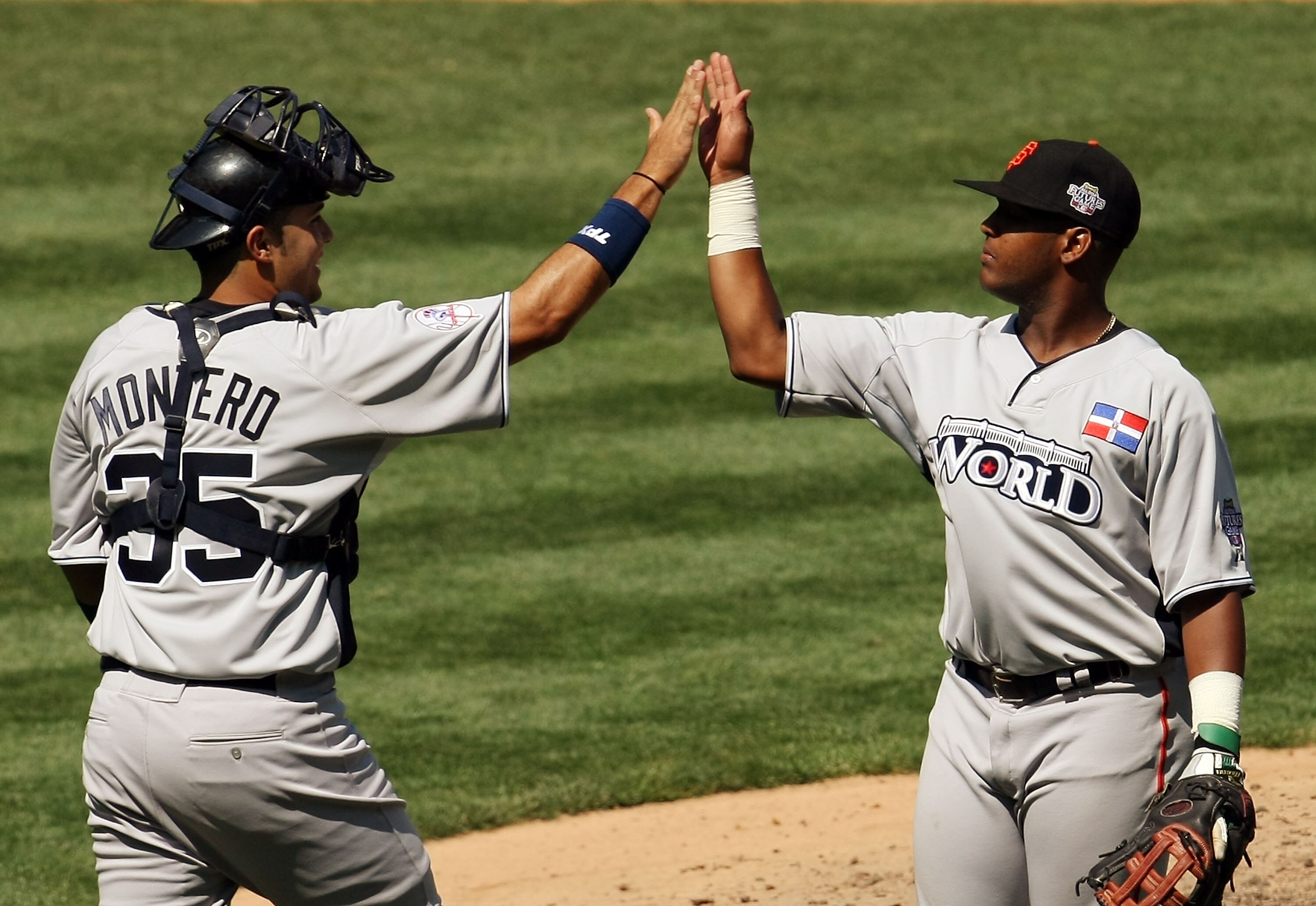 NEW YORK - JULY 13:  Shairon Martis #39 of the Washington Nationals playing for the World Futures Team celebrates with Jesus Montero #35 of the New York Yankees after defeating the United States Olympic team during the 2008 XM All-Star Futures Game at Yan