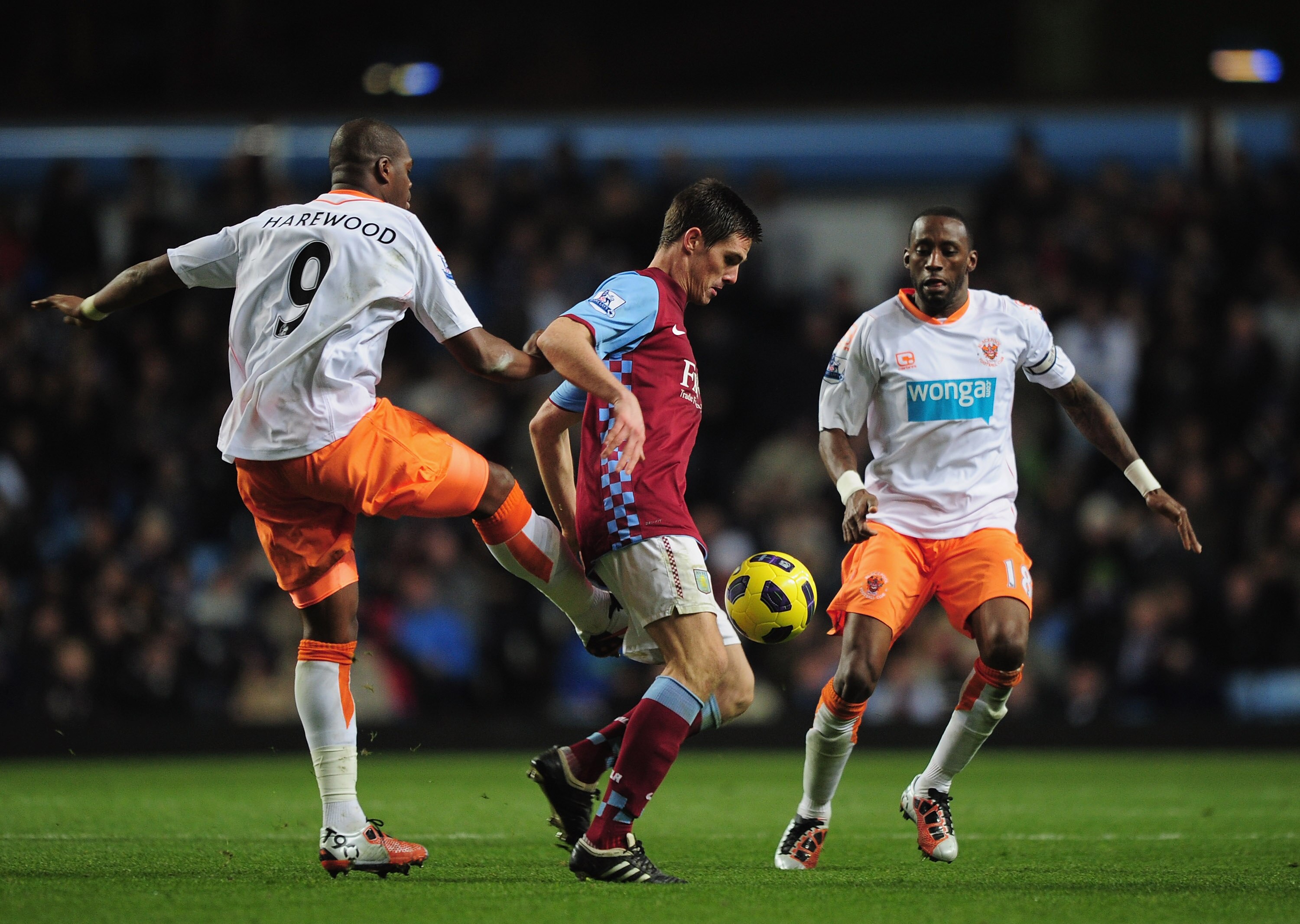 BIRMINGHAM, ENGLAND - NOVEMBER 10:  Ciaran Clark of Aston Villa is challenged by Marlon Harewood and Jason Euell of Blackpool during the Barclays Premier League match between Aston Villa and Blackpool at Villa Park on November 10, 2010 in Birmingham, Engl