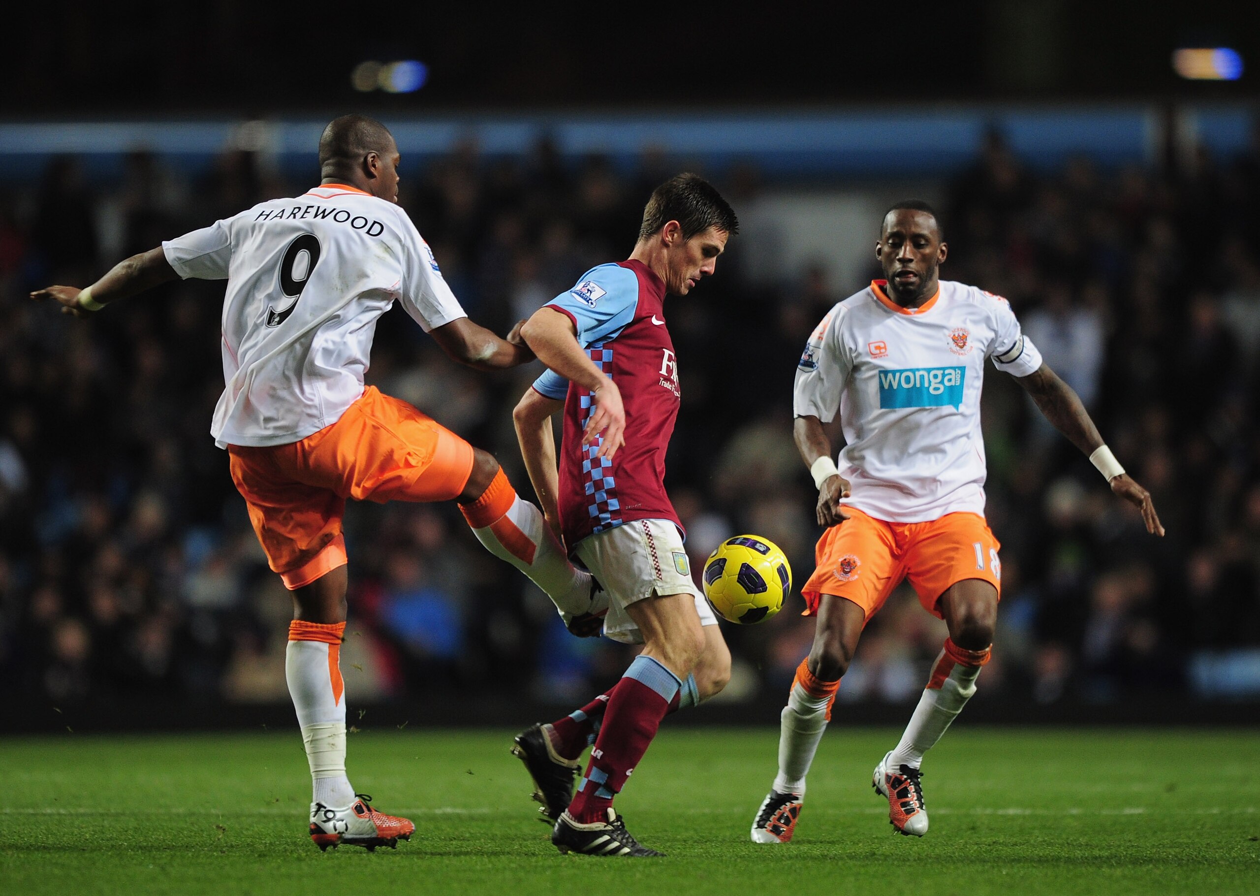 BIRMINGHAM, ENGLAND - NOVEMBER 10:  Ciaran Clark of Aston Villa is challenged by Marlon Harewood and Jason Euell of Blackpool during the Barclays Premier League match between Aston Villa and Blackpool at Villa Park on November 10, 2010 in Birmingham, Engl