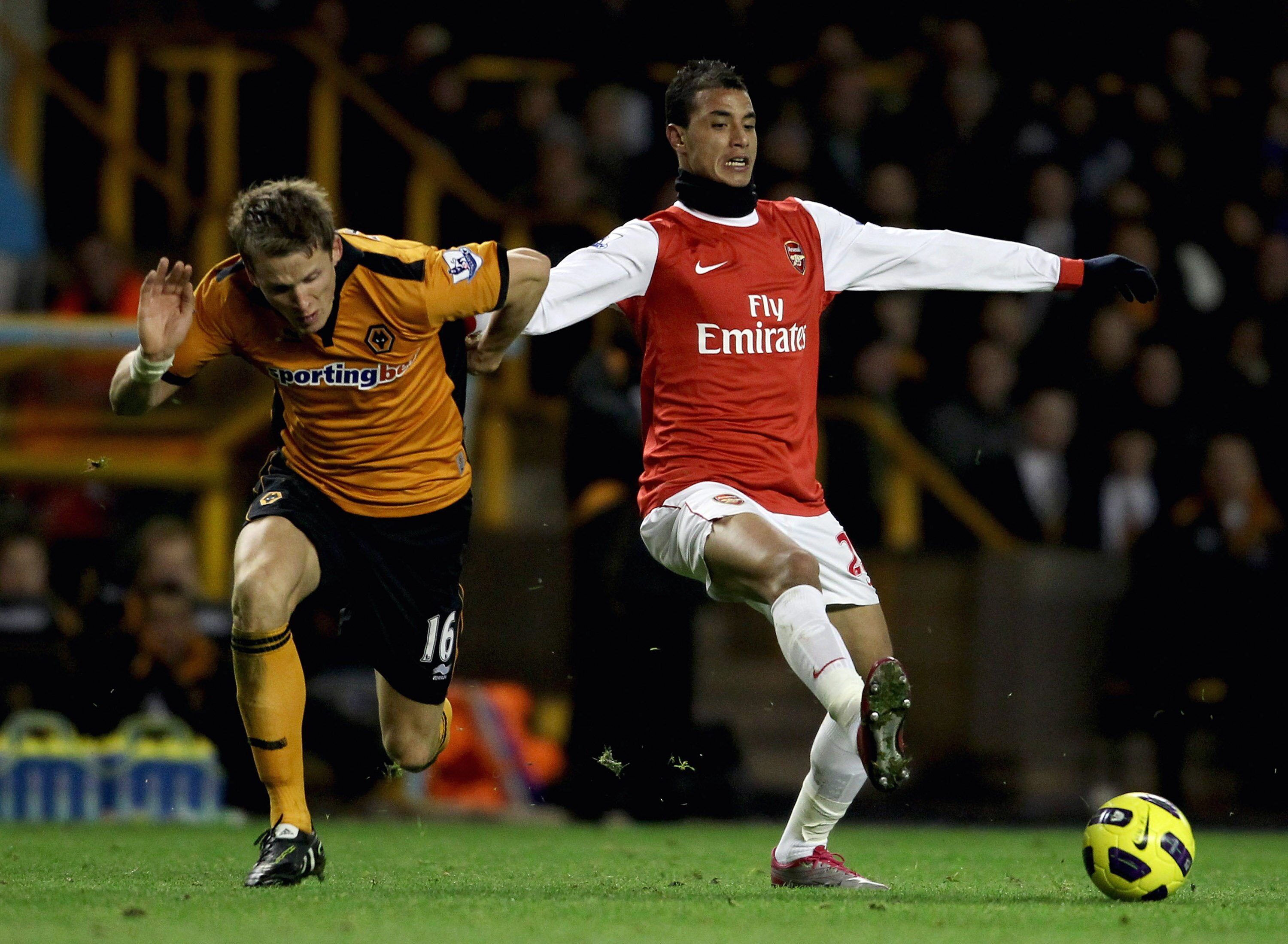WOLVERHAMPTON, ENGLAND - NOVEMBER 10:  Marouane Chamakh of Arsenal (R) in action with Christophe Berra of Wolverhampton during the Barclays Premier League match between Wolverhampton Wanderers and Arsenal, at Molineux  on November 10, 2010 in Wolverhampto