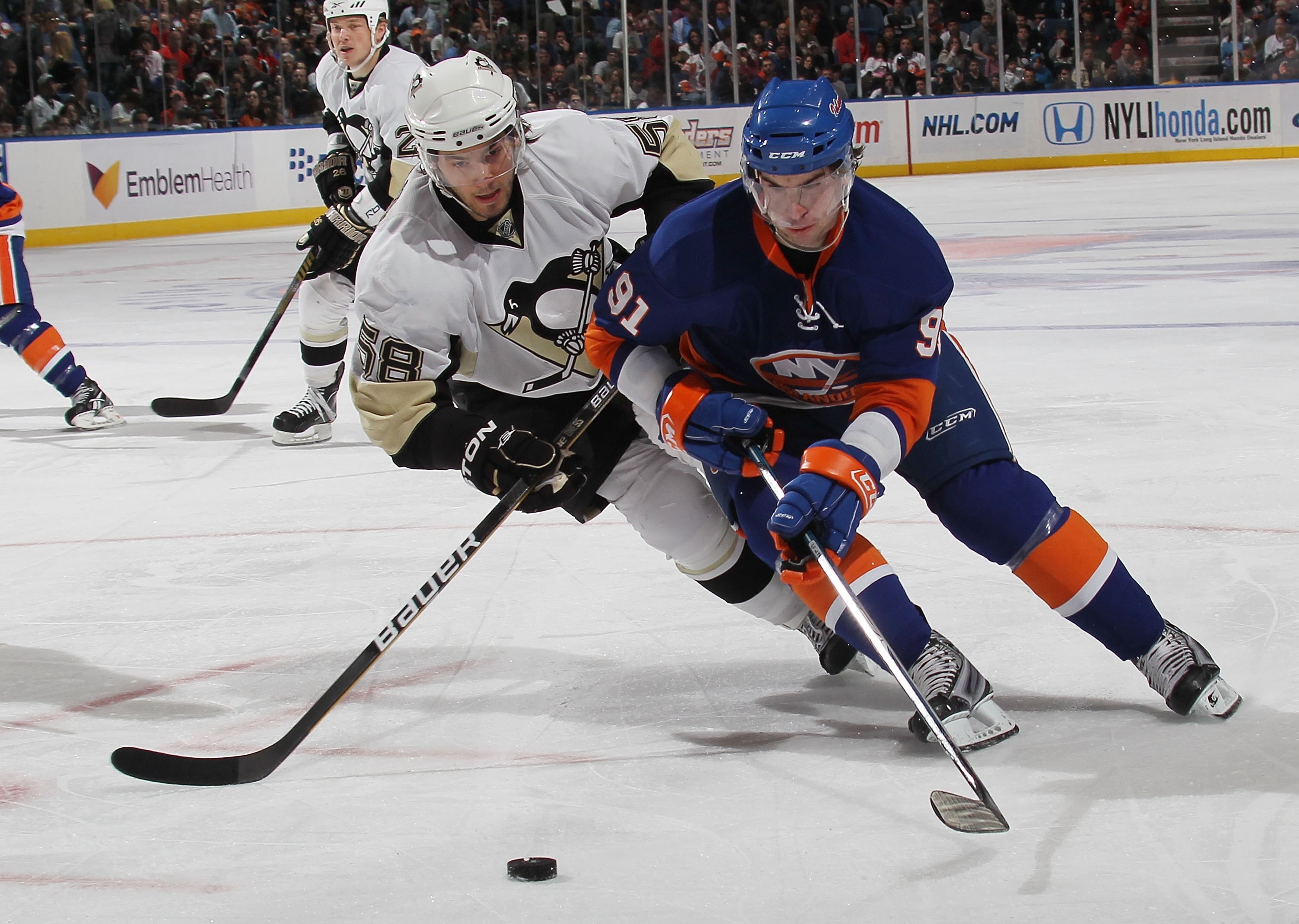 UNIONDALE, NY - APRIL 11: John Tavares #91 of the New York Islanders skates against Kris Letang #58 of the Pittsburgh Penguins at the Nassau Coliseum on April 11, 2010 in Uniondale, New York. (Photo by Bruce Bennett/Getty Images)