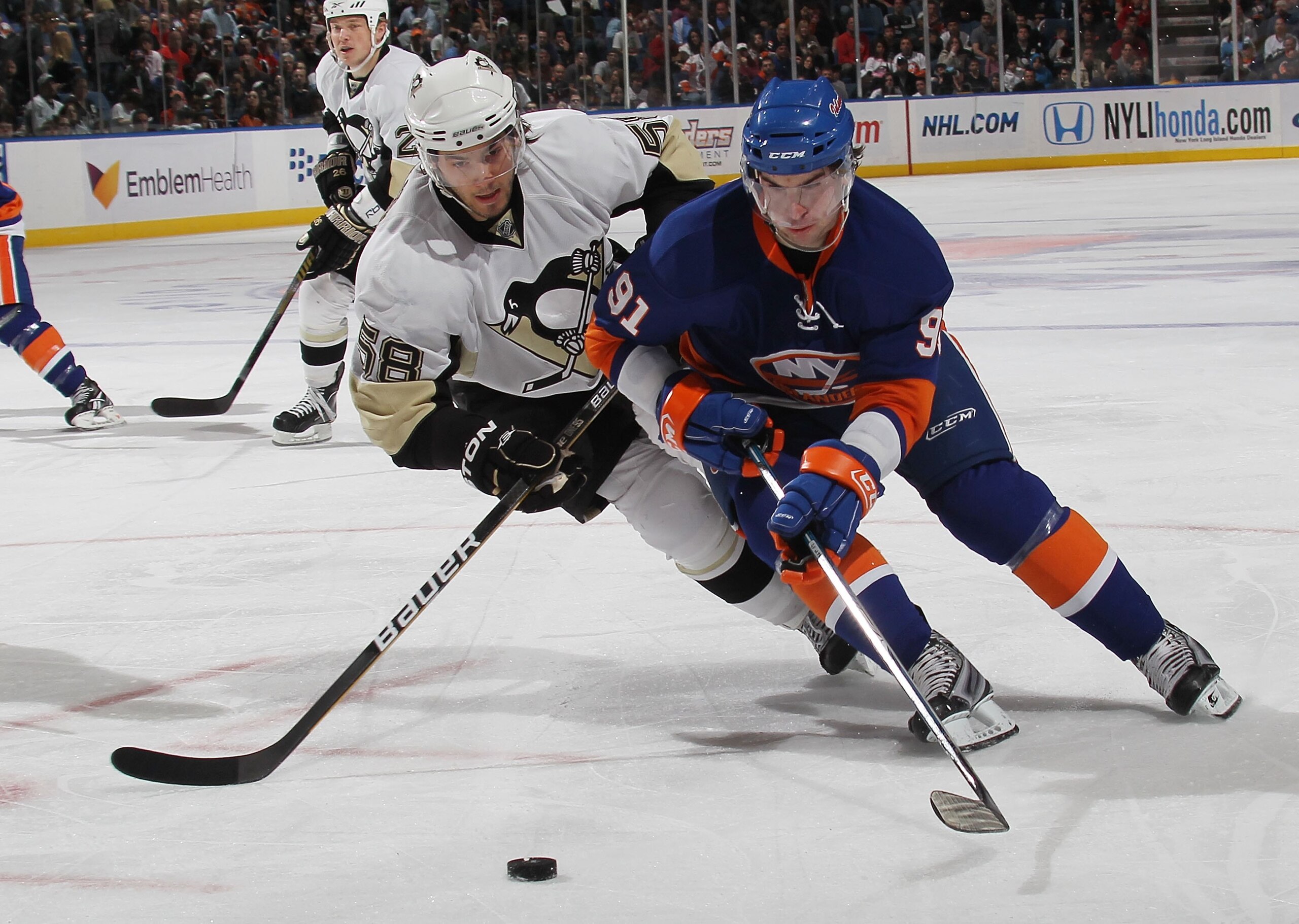 UNIONDALE, NY - APRIL 11: John Tavares #91 of the New York Islanders skates against Kris Letang #58 of the Pittsburgh Penguins at the Nassau Coliseum on April 11, 2010 in Uniondale, New York. (Photo by Bruce Bennett/Getty Images)