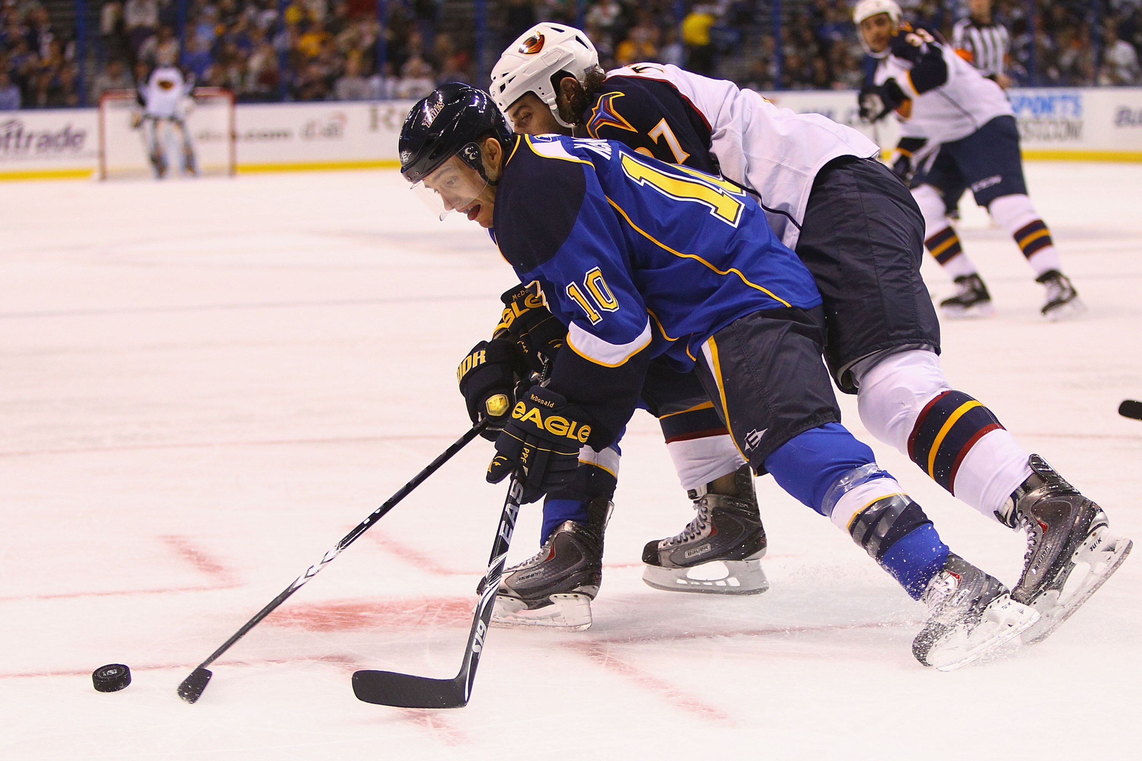ST. LOUIS - OCTOBER 30: Andy McDonald #10 of the St. Louis Blues looks to control the puck against the Atlanta Thrashers at the Scottrade Center on October 30, 2010 in St. Louis, Missouri.  (Photo by Dilip Vishwanat/Getty Images)