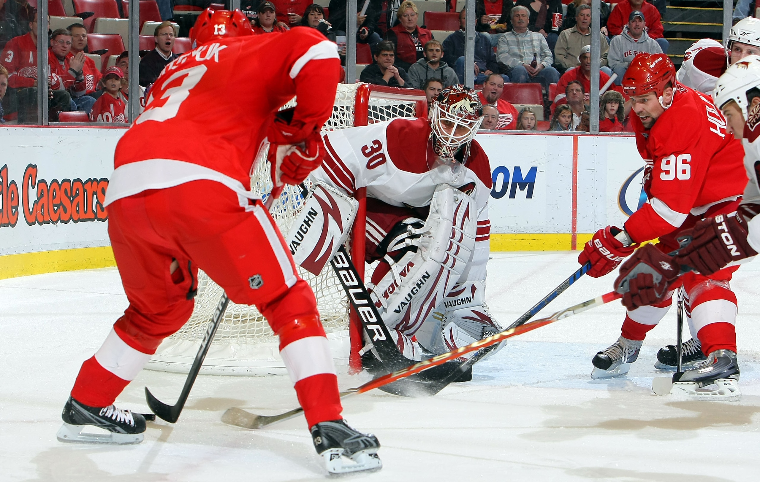 DETROIT - OCTOBER 28: Ilya Bryzgalov #30 of the Phoenix Coyotes keeps an eye on the puck as does Tomas Holmstrom #96 of the Detroit Red Wings while Pavel Datsyuk #13 of the Detroit Red Wings closes in on the net during their NHL game at Joe Louis Arena o DETROIT - OCTOBER 28: Ilya Bryzgalov #30 of the Phoenix Coyotes keeps an eye on the puck as does Tomas Holmstrom #96 of the Detroit Red Wings while Pavel Datsyuk #13 of the Detroit Red Wings closes in on the net during their NHL game at Joe Louis Arena o