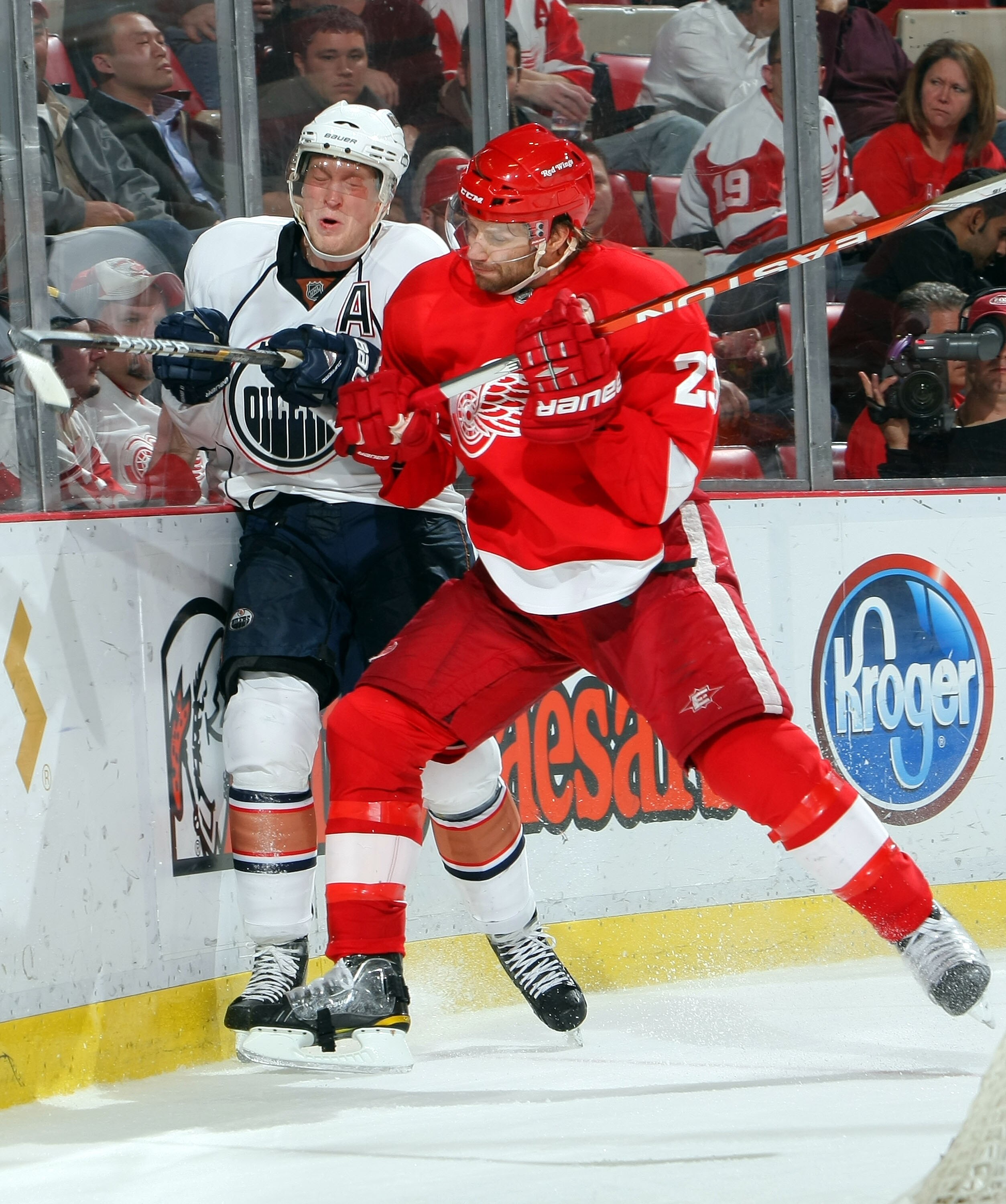 DETROIT - NOVEMBER 11:  Ales Hemsky #83 of the Edmonton Oilers is checked by Brad Stuart #23 of the Detroit Red Wings during their NHL game at Joe Louis Arena on November 11, 2010 in Detroit, Michigan.(Photo By Dave Sandford/Getty Images)
