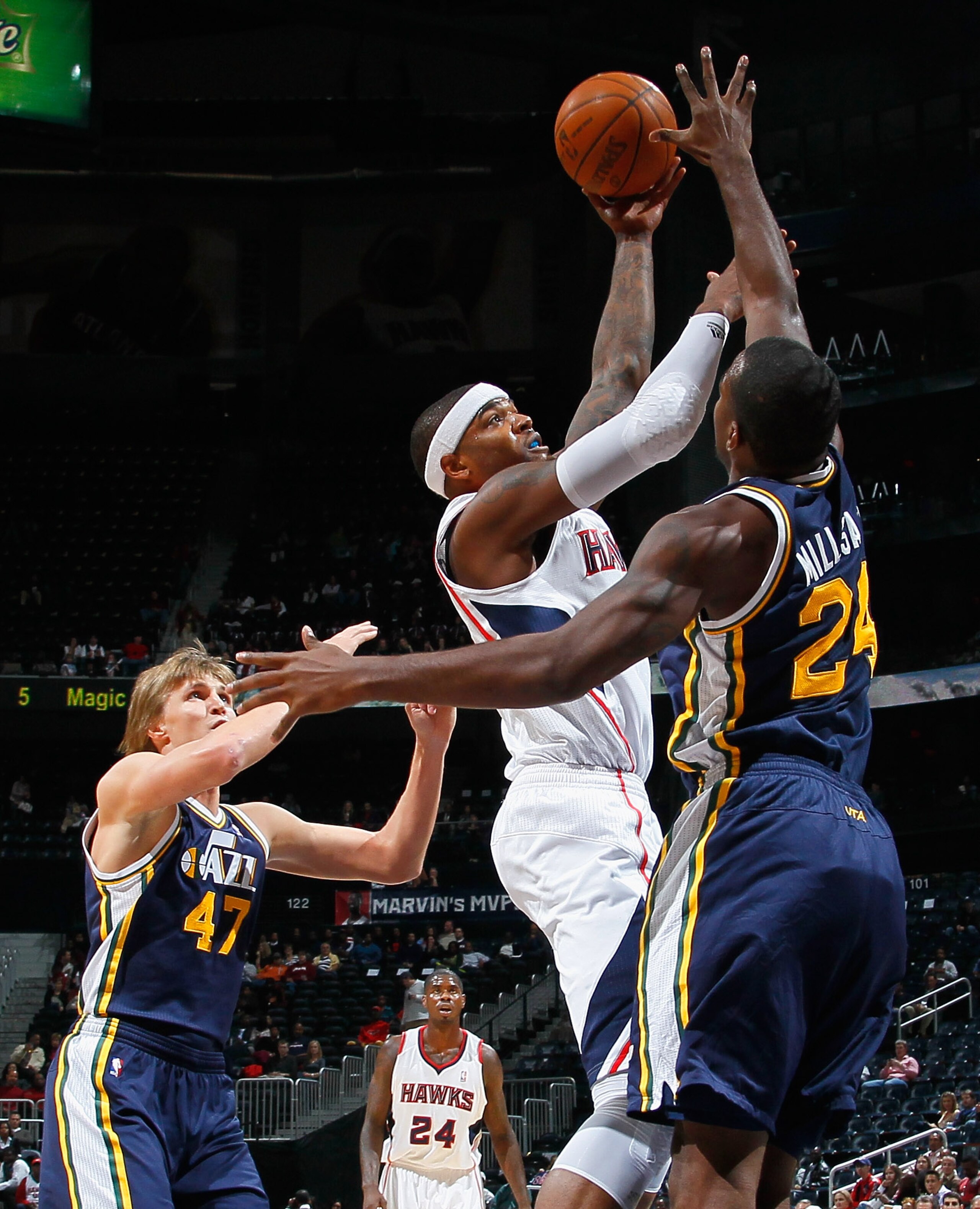 ATLANTA - NOVEMBER 12:  Josh Smith #5 of the Atlanta Hawks shoots against Andrei Kirilenko #47 and Paul Millsap #24 of the Utah Jazz at Philips Arena on November 12, 2010 in Atlanta, Georgia.  NOTE TO USER: User expressly acknowledges and agrees that, by