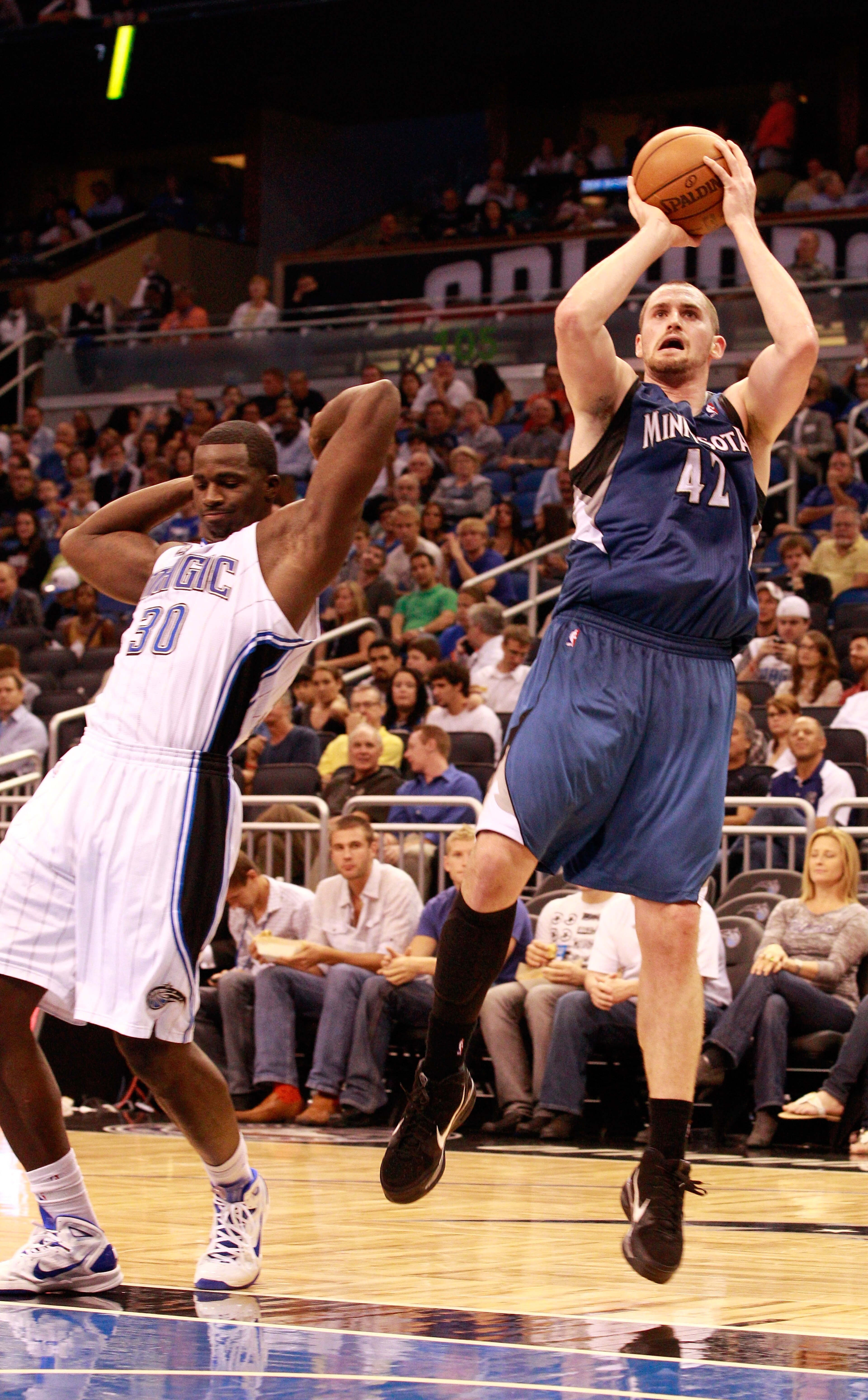 ORLANDO, FL - NOVEMBER 03: Kevin Love #42 of the Minnesota Timberwolves attempts a shot over Brandon Bass #30 of the Orlando Magic during the game at Amway Arena on November 3, 2010 in Orlando, Florida. NOTE TO USER: User expressly acknowledges and agre ORLANDO, FL - NOVEMBER 03: Kevin Love #42 of the Minnesota Timberwolves attempts a shot over Brandon Bass #30 of the Orlando Magic during the game at Amway Arena on November 3, 2010 in Orlando, Florida. NOTE TO USER: User expressly acknowledges and agre