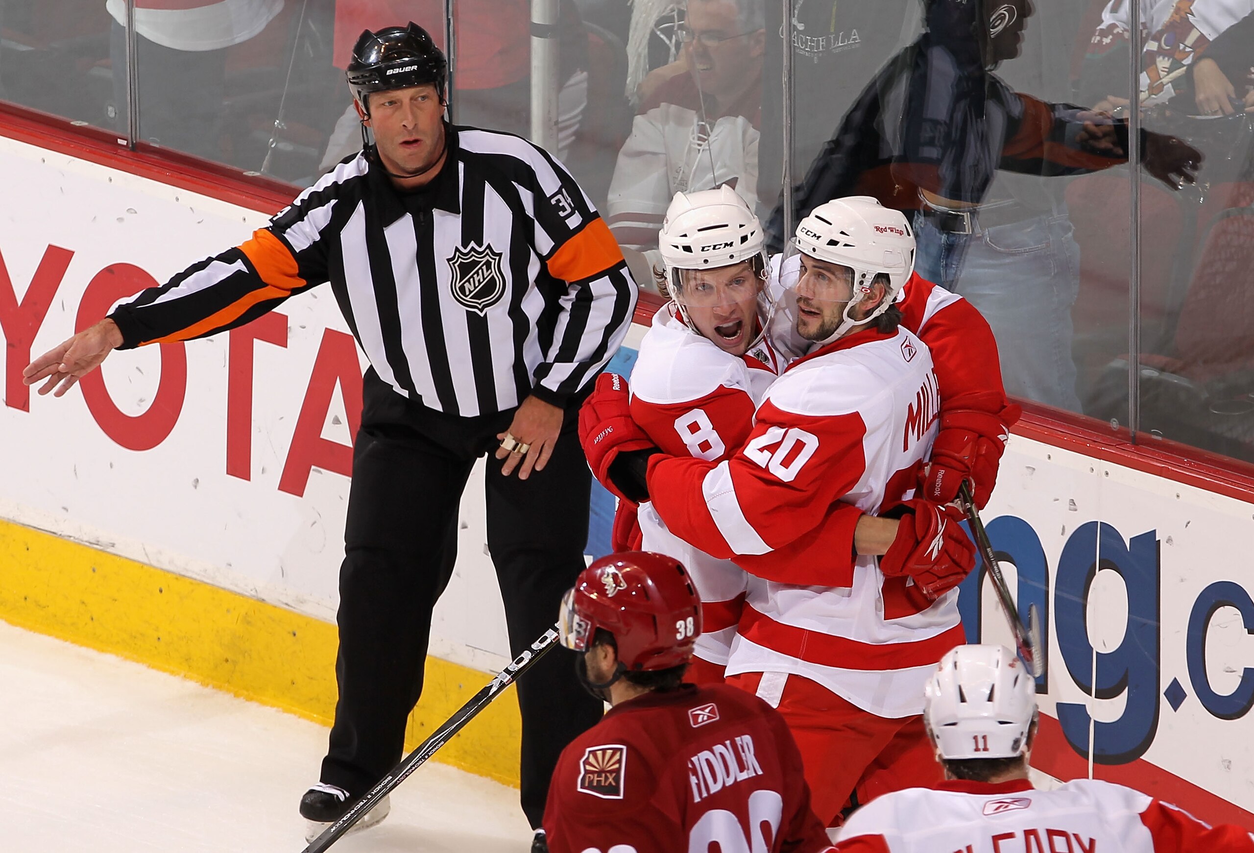 GLENDALE, AZ - APRIL 23: Drew Miller #20 of the Detroit Red Wings celebrates with teammate Justin Abdelkader #8 after Miller scored a first period goal against the Phoenix Coyotes in Game Five of the Western Conference Quarterfinals during the 2010 NHL S GLENDALE, AZ - APRIL 23: Drew Miller #20 of the Detroit Red Wings celebrates with teammate Justin Abdelkader #8 after Miller scored a first period goal against the Phoenix Coyotes in Game Five of the Western Conference Quarterfinals during the 2010 NHL S