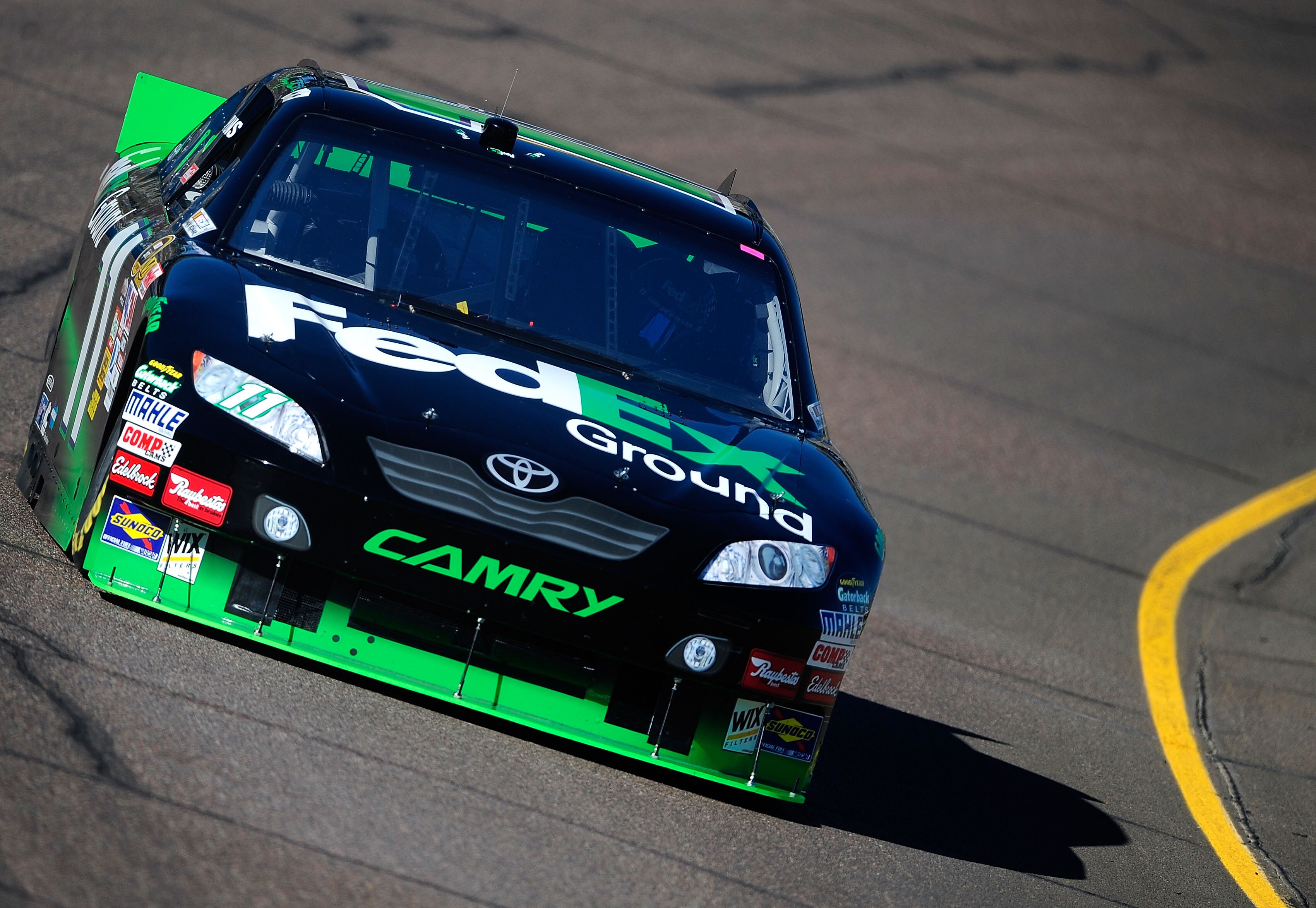 AVONDALE, AZ - NOVEMBER 12:  Denny Hamlin, driver of the #11 FedEx Toyota, practices for the NASCAR Sprint Cup Series Kobalt Tools 500 at Phoenix International Raceway on November 12, 2010 in Avondale, Arizona.  (Photo by Rusty Jarrett/Getty Images for NA