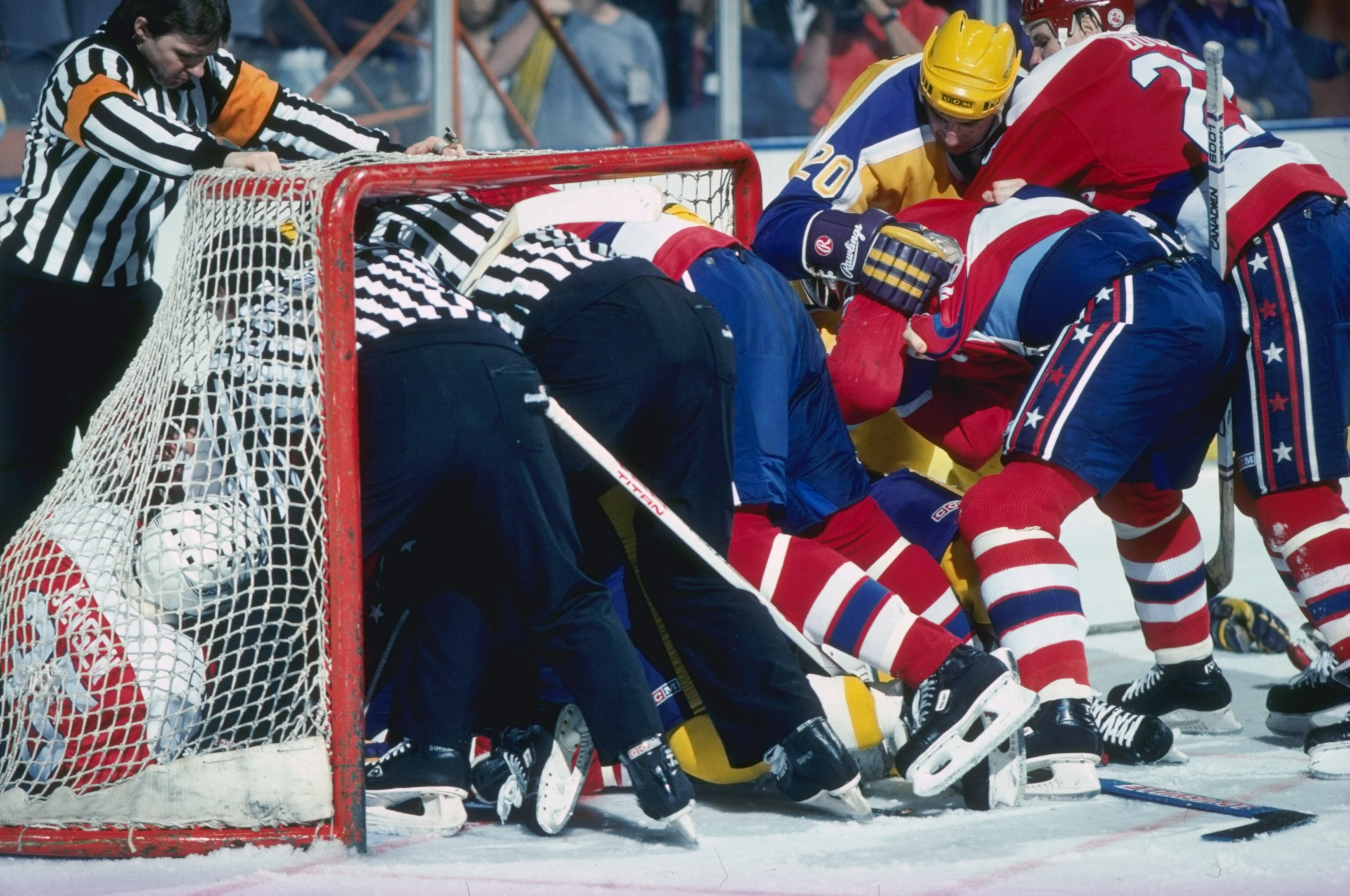 Undated:  Two linesmen break up a fight inside the net during a game between the Los Angeles Kings and the Washington Capitals. Mandatory Credit: Rick Stewart  /Allsport