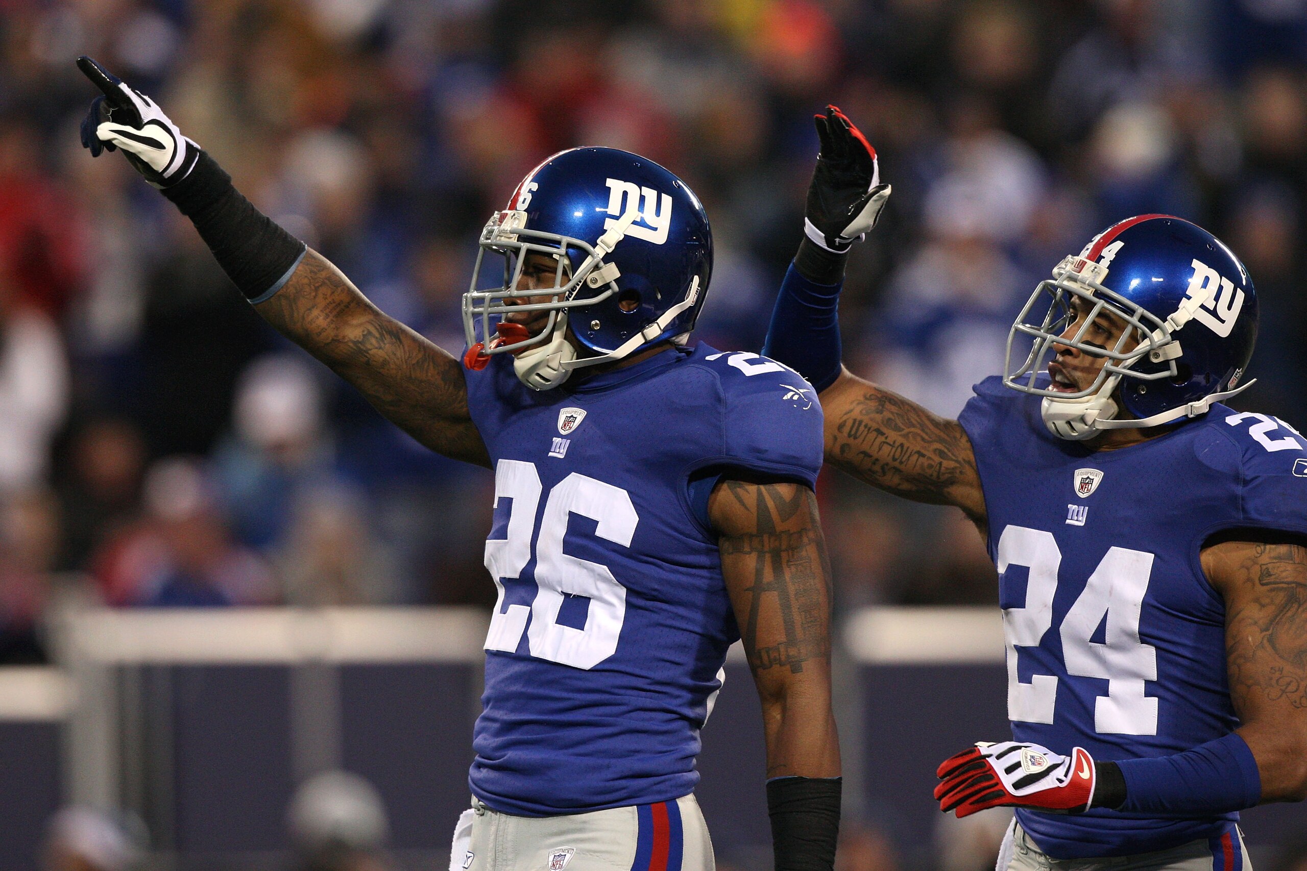 EAST RUTHERFORD, NJ - DECEMBER 06:  (L-R) Aaron Rouse #26 and Terrell Thomas #24 of the New York Giants celebrate a defensive play against the Dallas Cowboys at Giants Stadium on December 6, 2009 in East Rutherford, New Jersey.  (Photo by Jim McIsaac/Gett