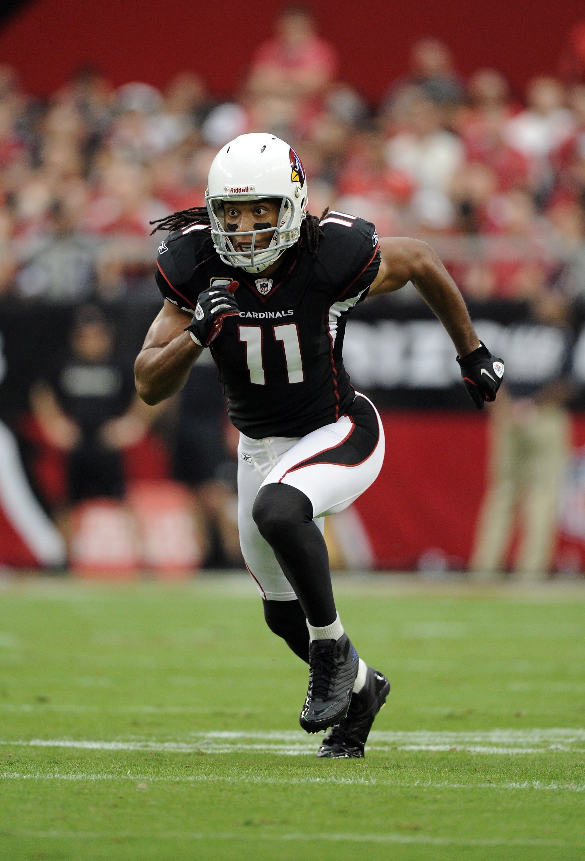 GLENDALE, AZ - OCTOBER 31:  Larry Fitzgerald #11 of the Arizona Cardinals comes off the line of scrimmage against the Tampa Bay Buccaneers at University of Phoenix Stadium on October 31, 2010 in Glendale, Arizona.  (Photo by Harry How/Getty Images)