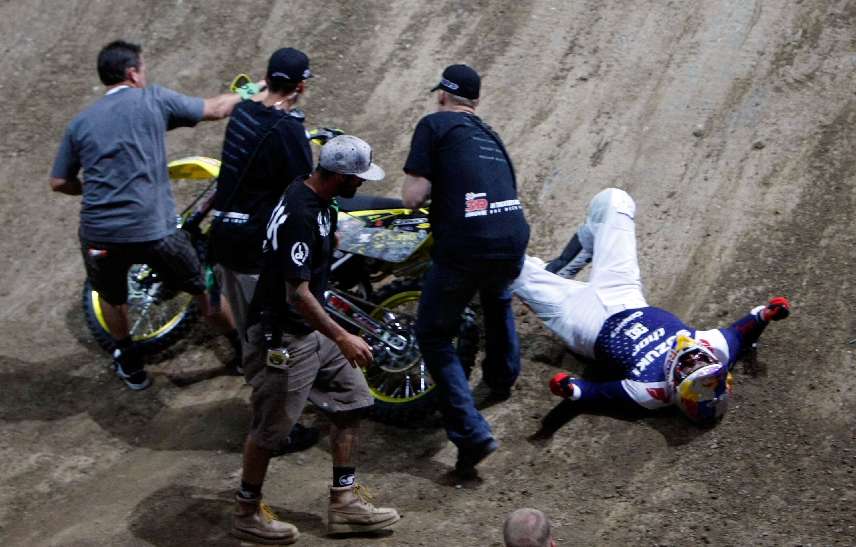 LOS ANGELES, CA - JULY 31:  Travis Pastrana is attended to after crashing while competing in the Moto X Best Trick Final during X Games 15 at Staples Center on July 31, 2009 in Los Angeles, California.  (Photo by Jeff Gross/Getty Images)