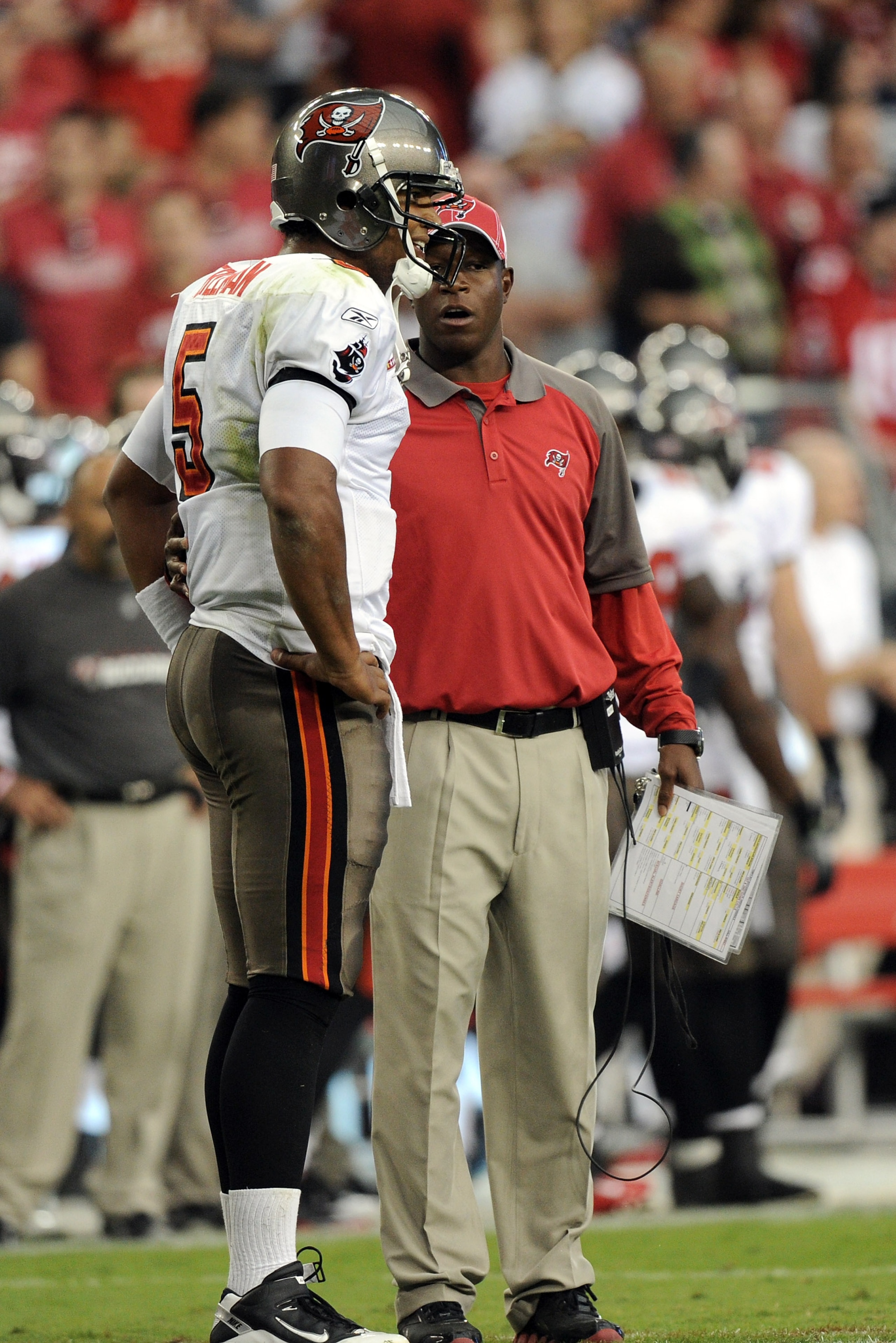 GLENDALE, AZ - OCTOBER 31:  Josh Freeman #5 of the Tampa Bay Buccaneers speaks to Head Coach Raheem Morris during a timeout against the Arizona Cardinals at University of Phoenix Stadium on October 31, 2010 in Glendale, Arizona.  (Photo by Harry How/Getty